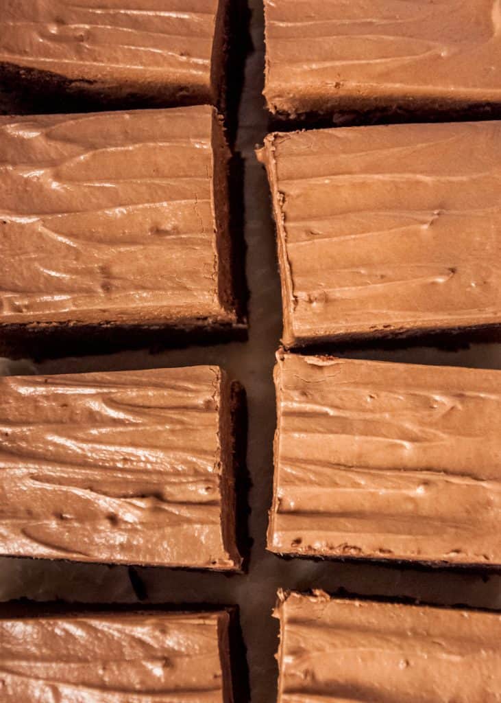 Nutella brownies cut into squares on a baking sheet with parchment paper from overhead.