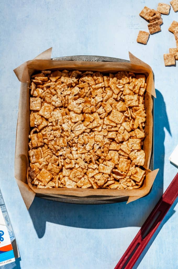 cinnamon toast crunch cereal bars pressed into pan, cooling before slicing