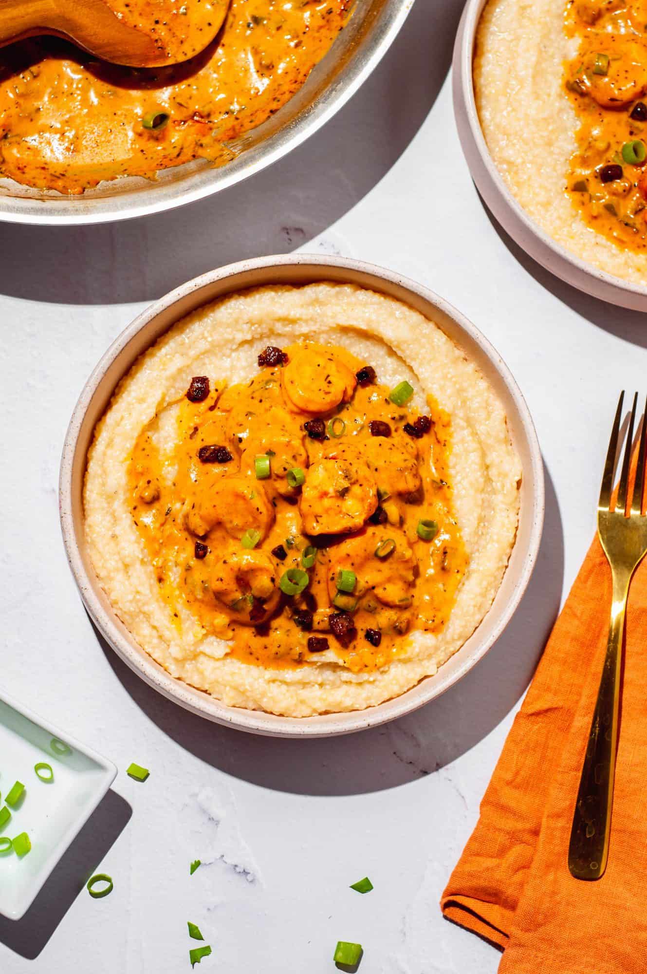 Shrimp with cajun cream sauce, sausage and scallions served over grits