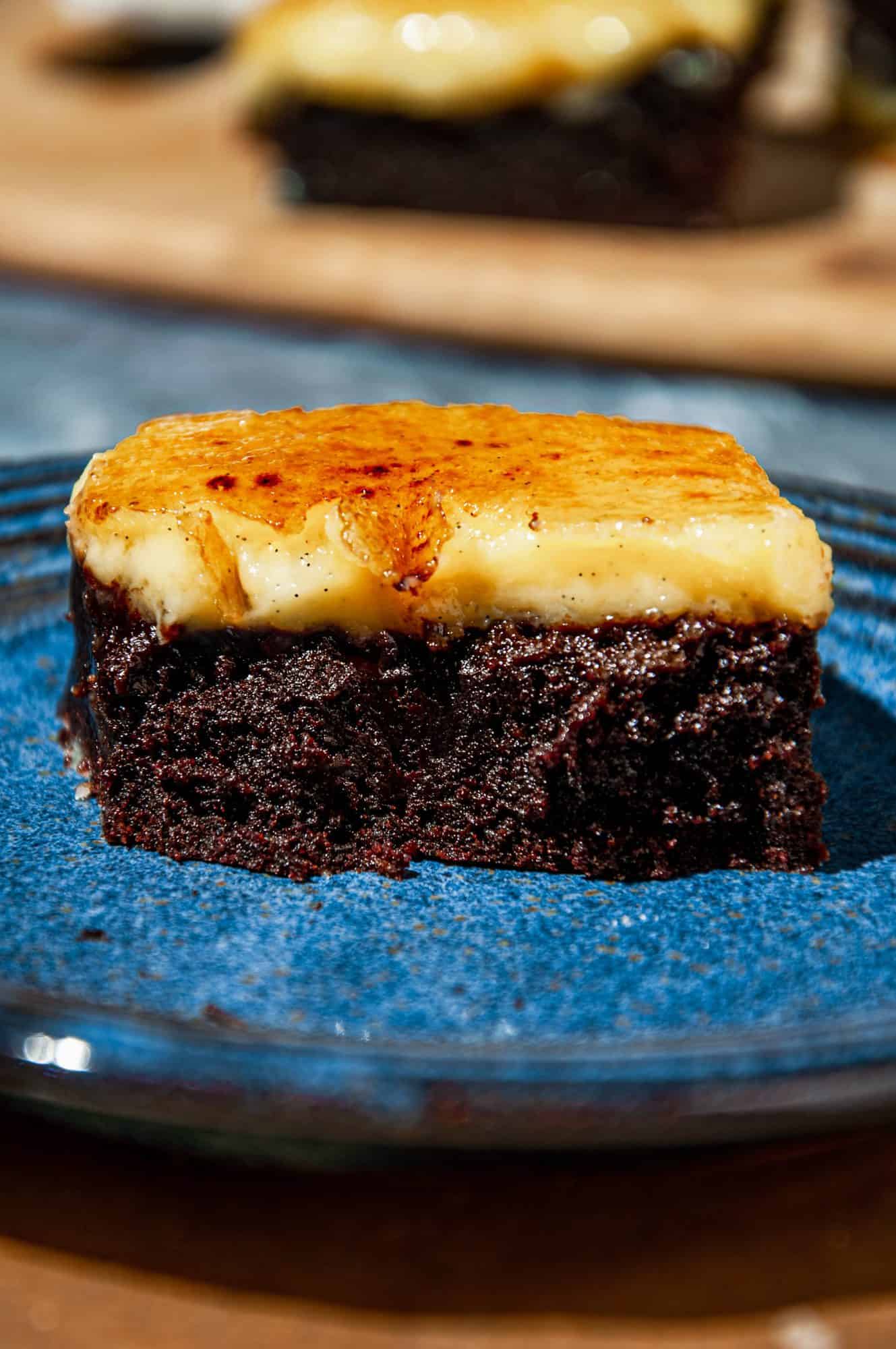 Brownie showing interior layers of chocolate brownie, creamy vanilla bean creme brûlée, crunchy caramelized sugar topping. 