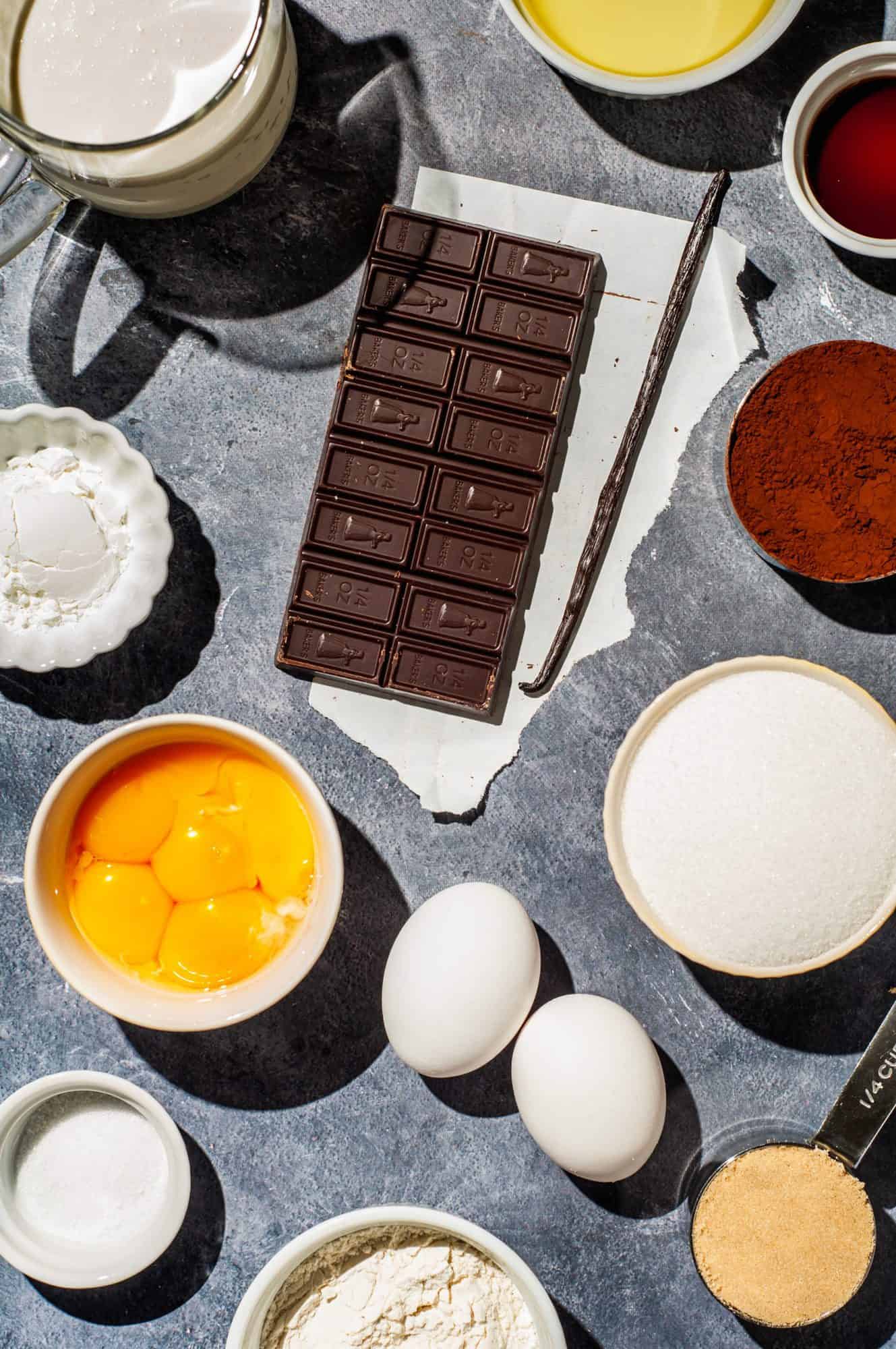 Ingredients needed to make creme brûlée brownies: cream, vegetable oil, vanilla, cocoa powder, chocolate, vanilla bean, sugar, cornstarch, eggs, egg yolks, brown sugar, flour, salt