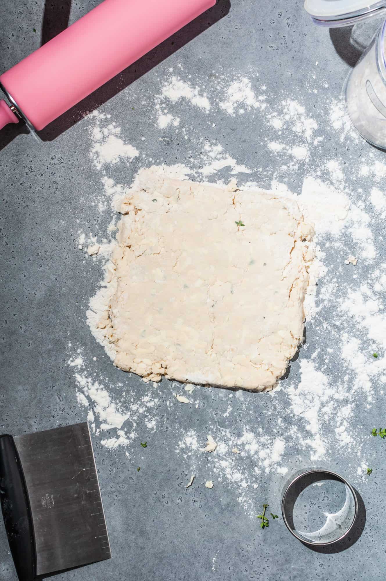 thyme butter biscuit dough rolled out into a square