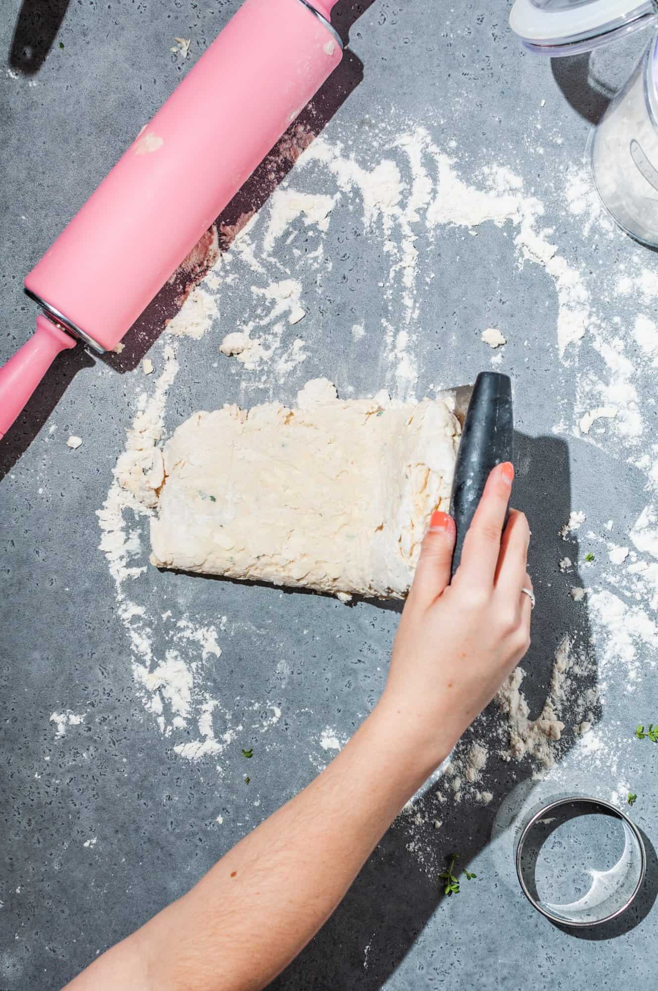 folding biscuit dough in quarters to create flaky layers