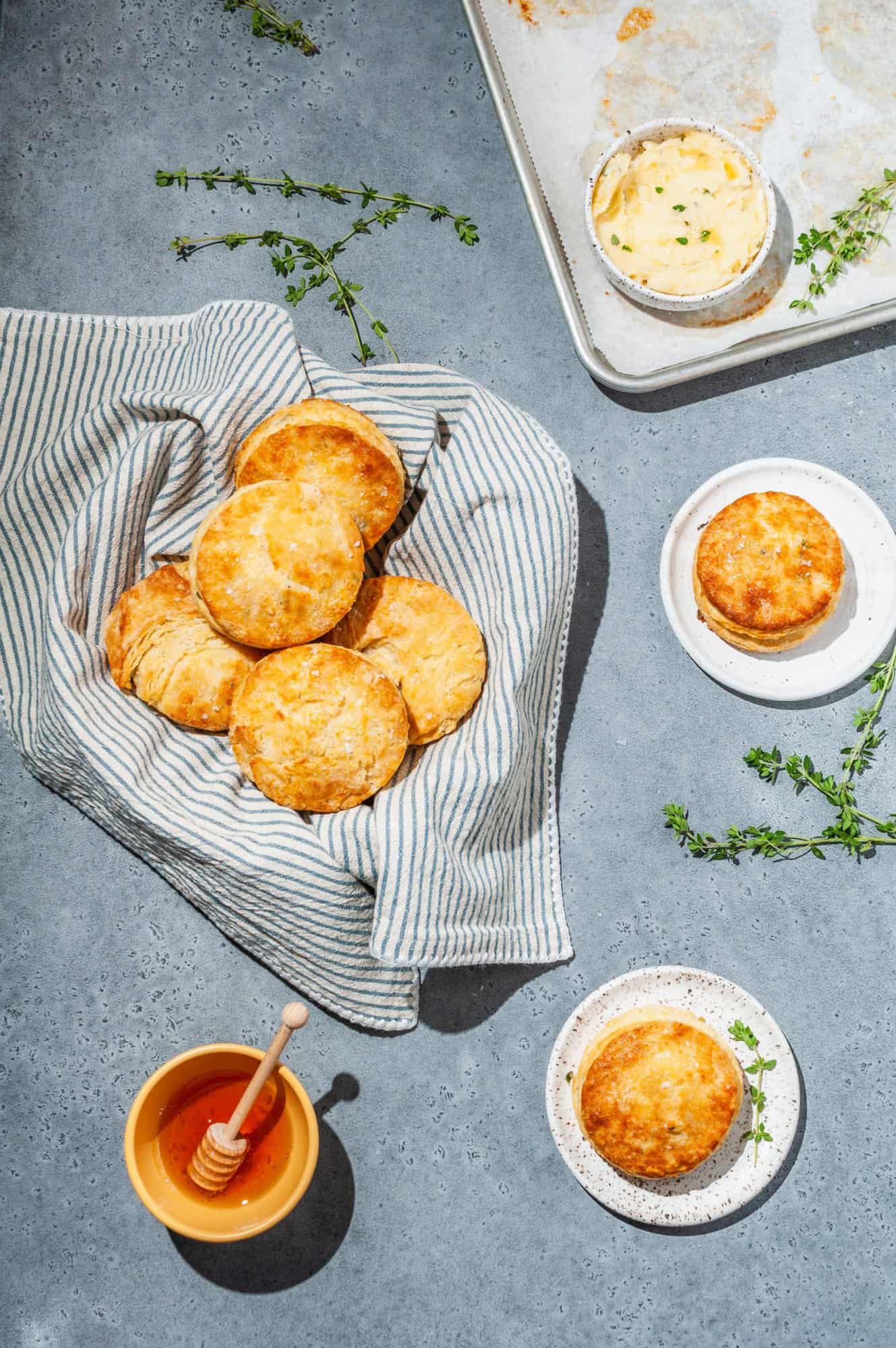 basket with honey butter biscuits, extra thyme butter and honey on the side