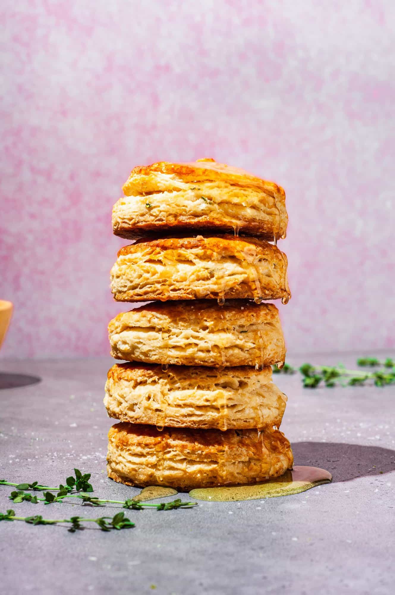 stack of 5 biscuits with honey dripping down the side