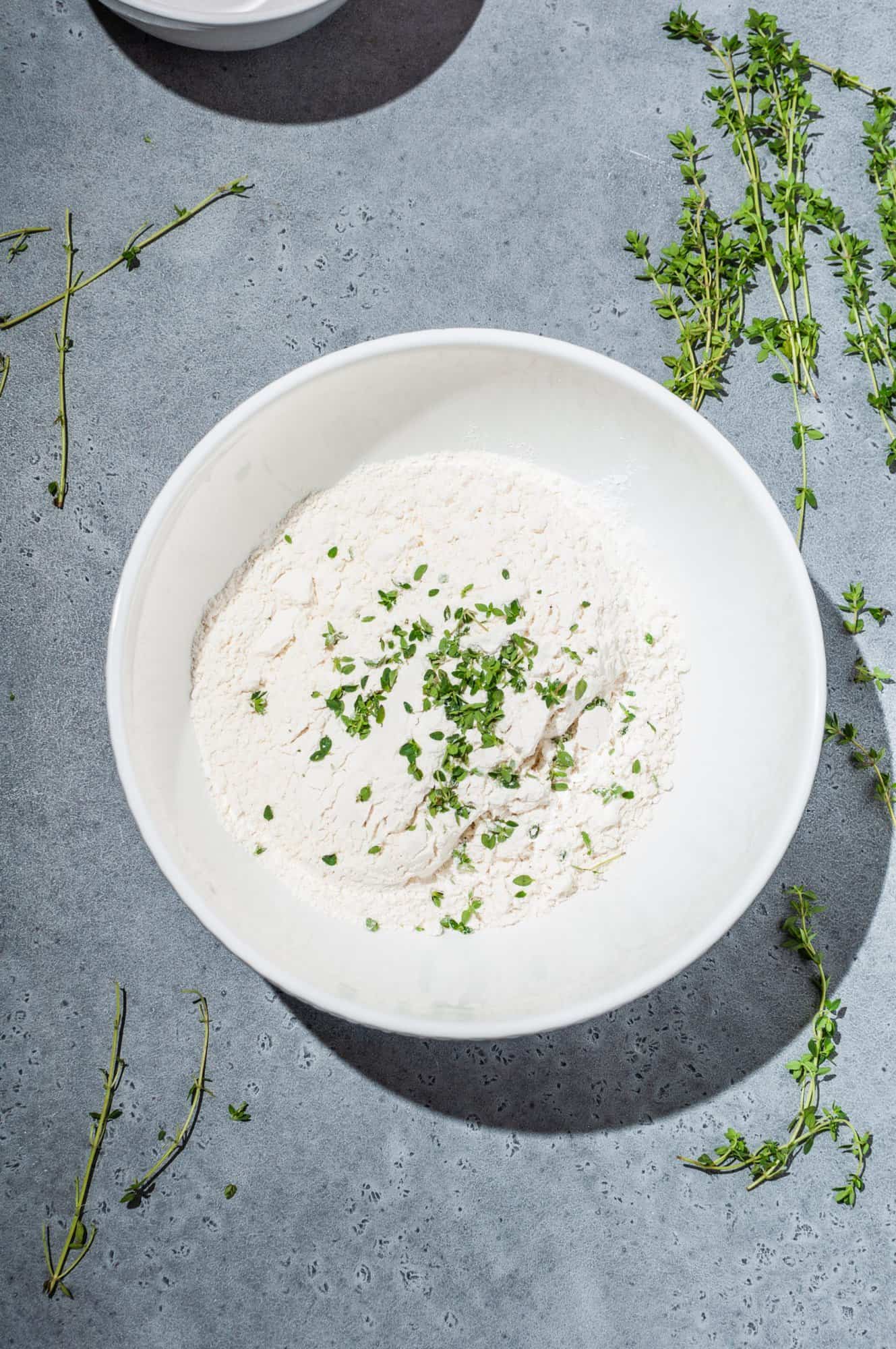 bowl of flour mixture with thyme