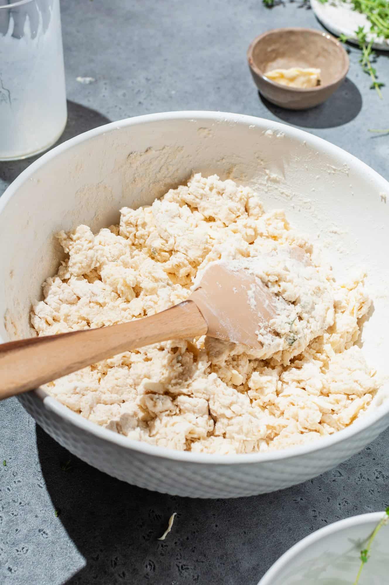 bowl of shaggy biscuit dough with spatula