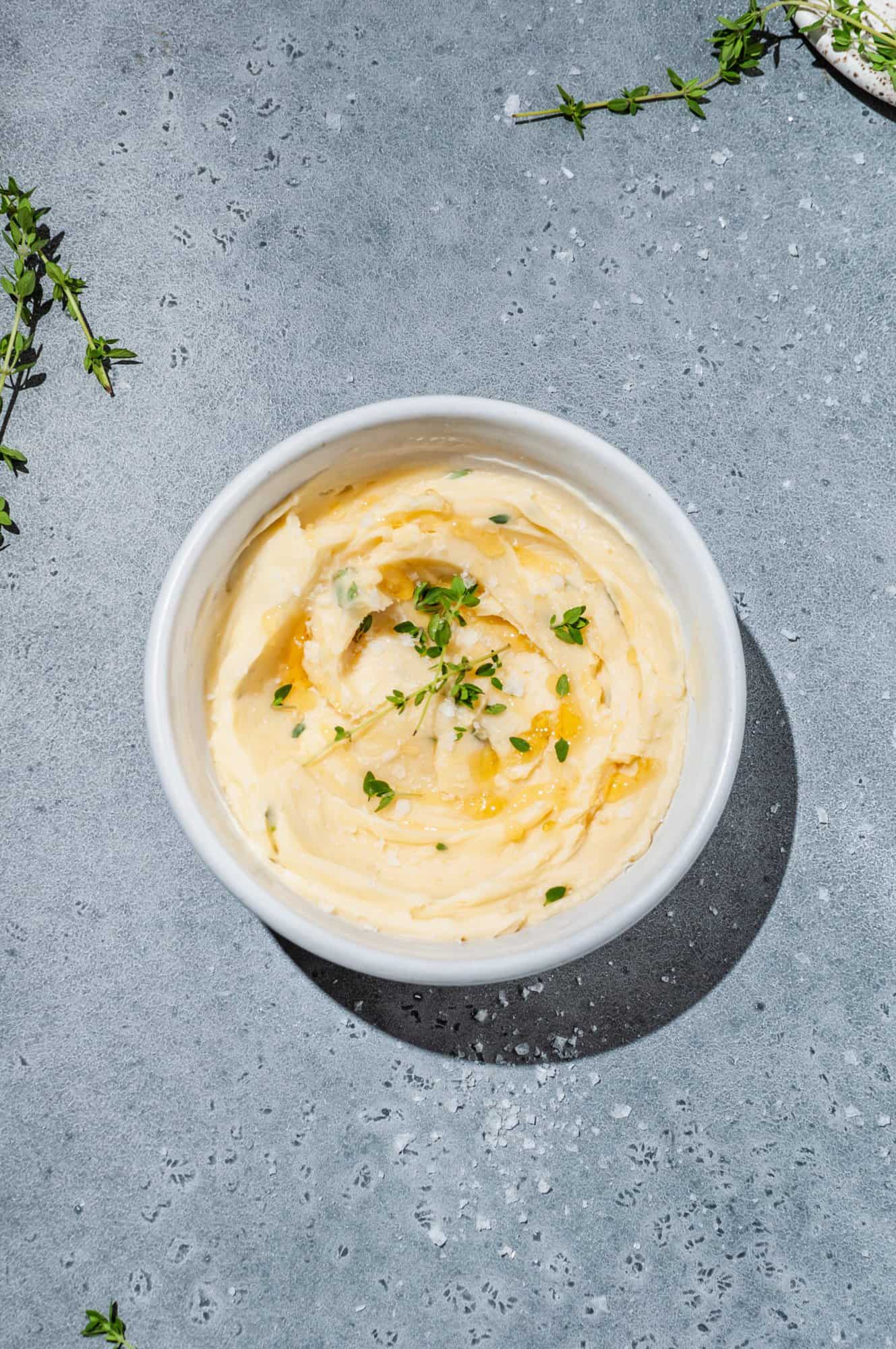 bowl of thyme compound butter with honey and flaky sea salt