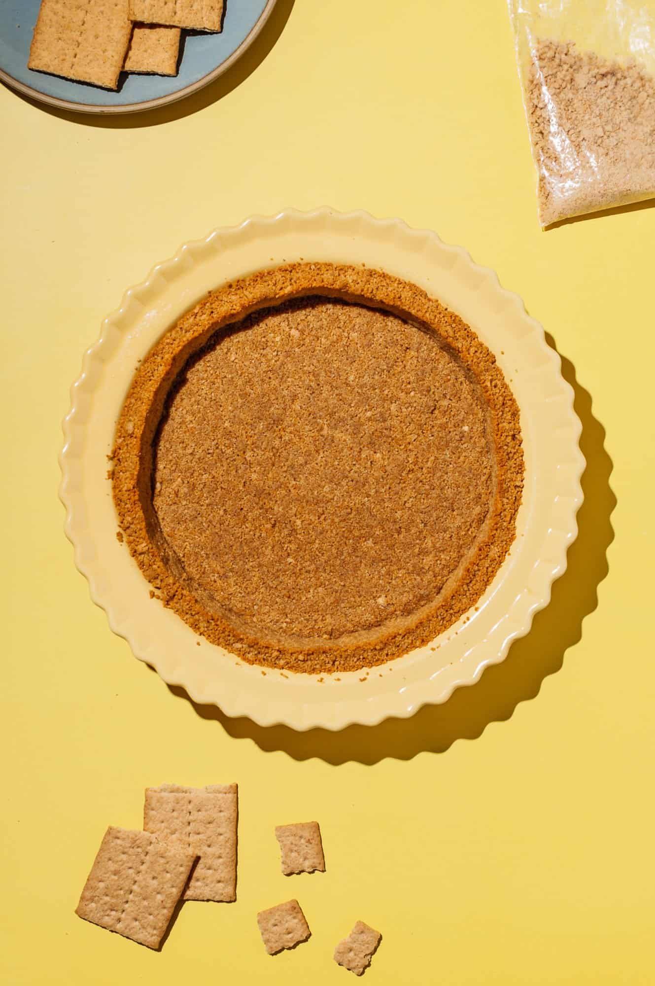 extra thick graham cracker crust in yellow pie plate, baked