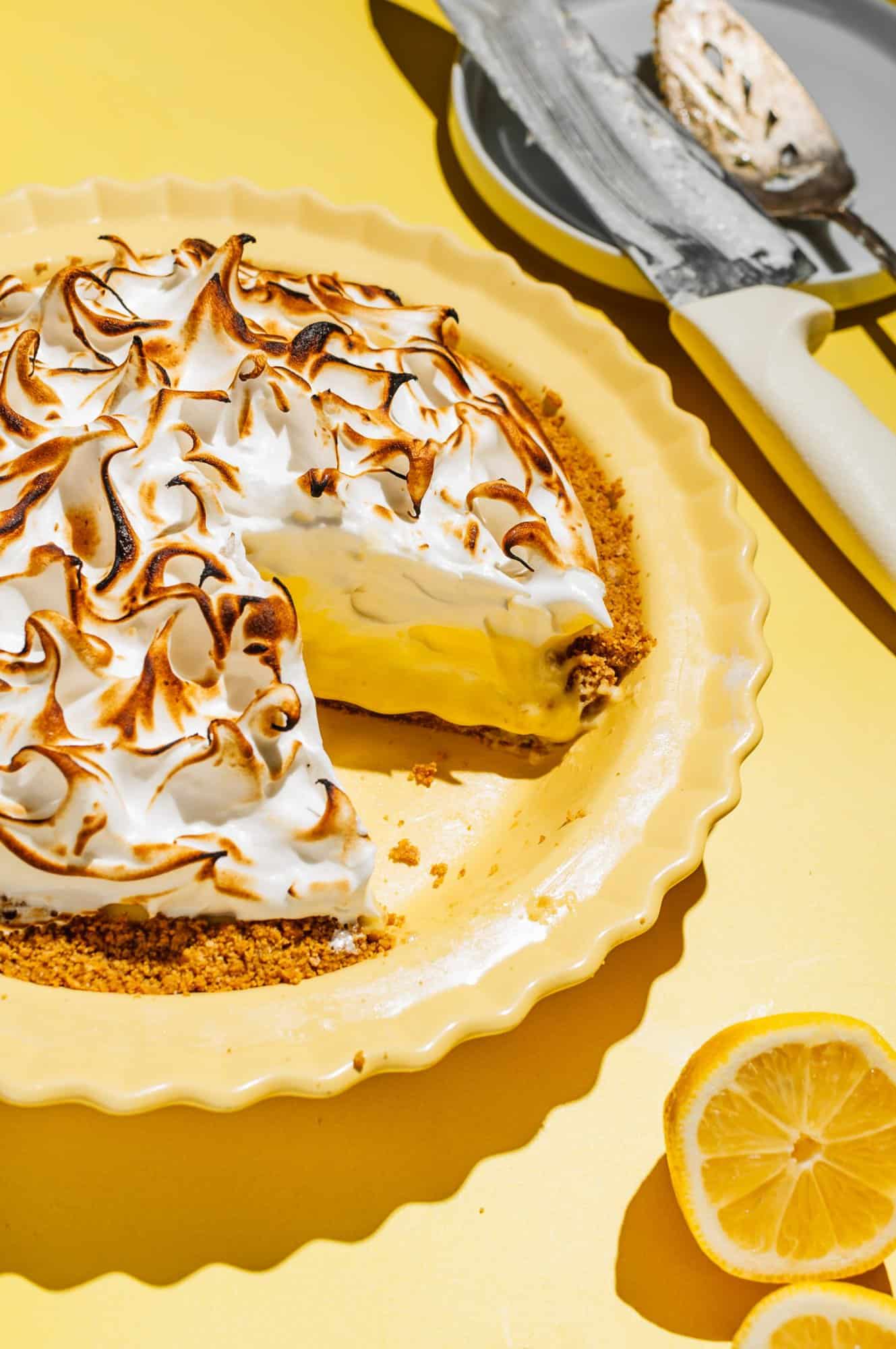 lemon meringue pie with a slice taken out