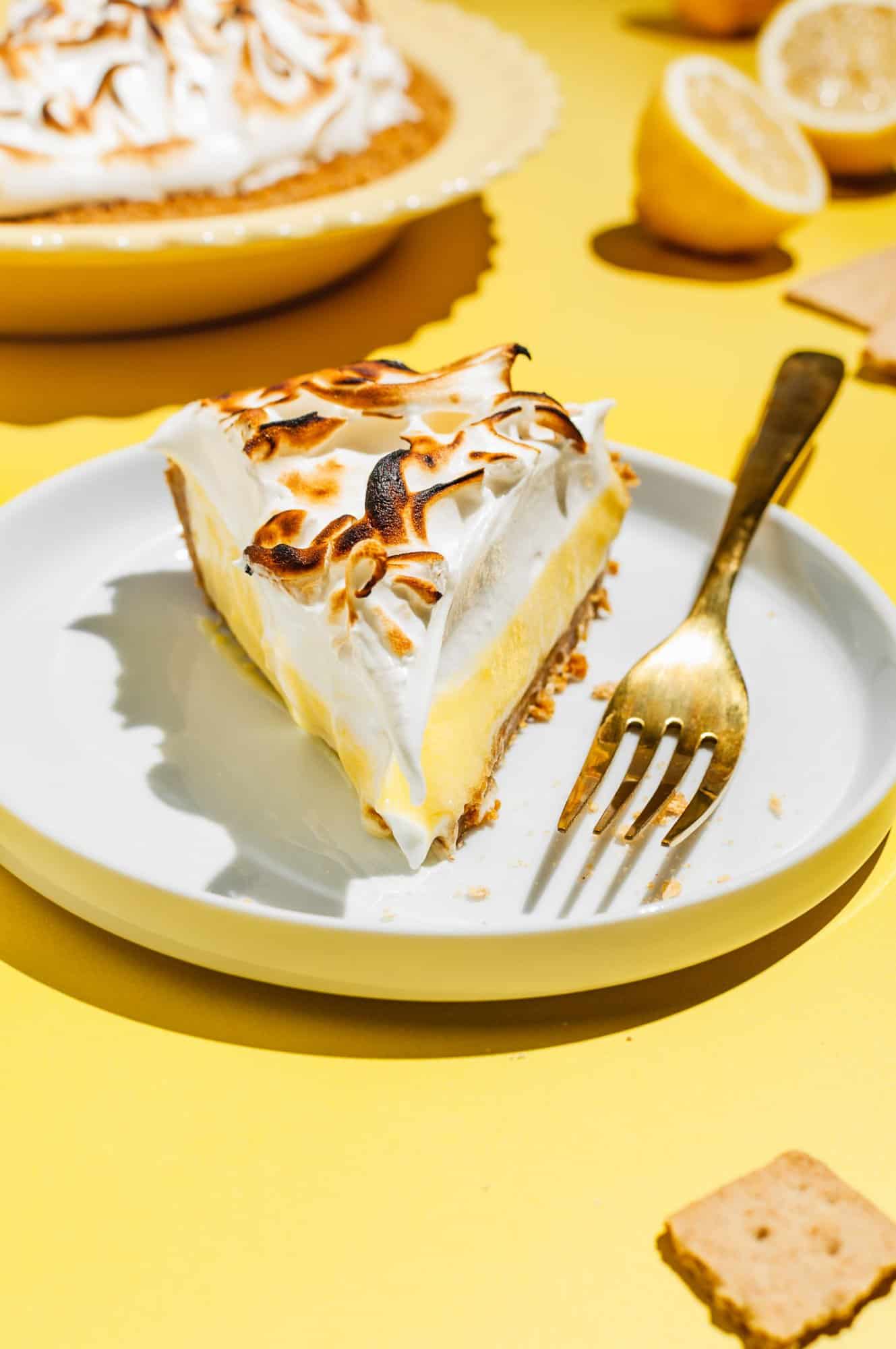 a slice of lemon meringue pie on a white plate