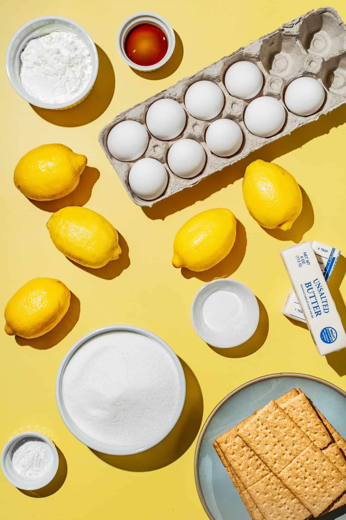 ingredients to make meringue pie: lemons, cornstarch, vanilla, eggs, butter, salt, sugar, graham crackers, cream of tartar