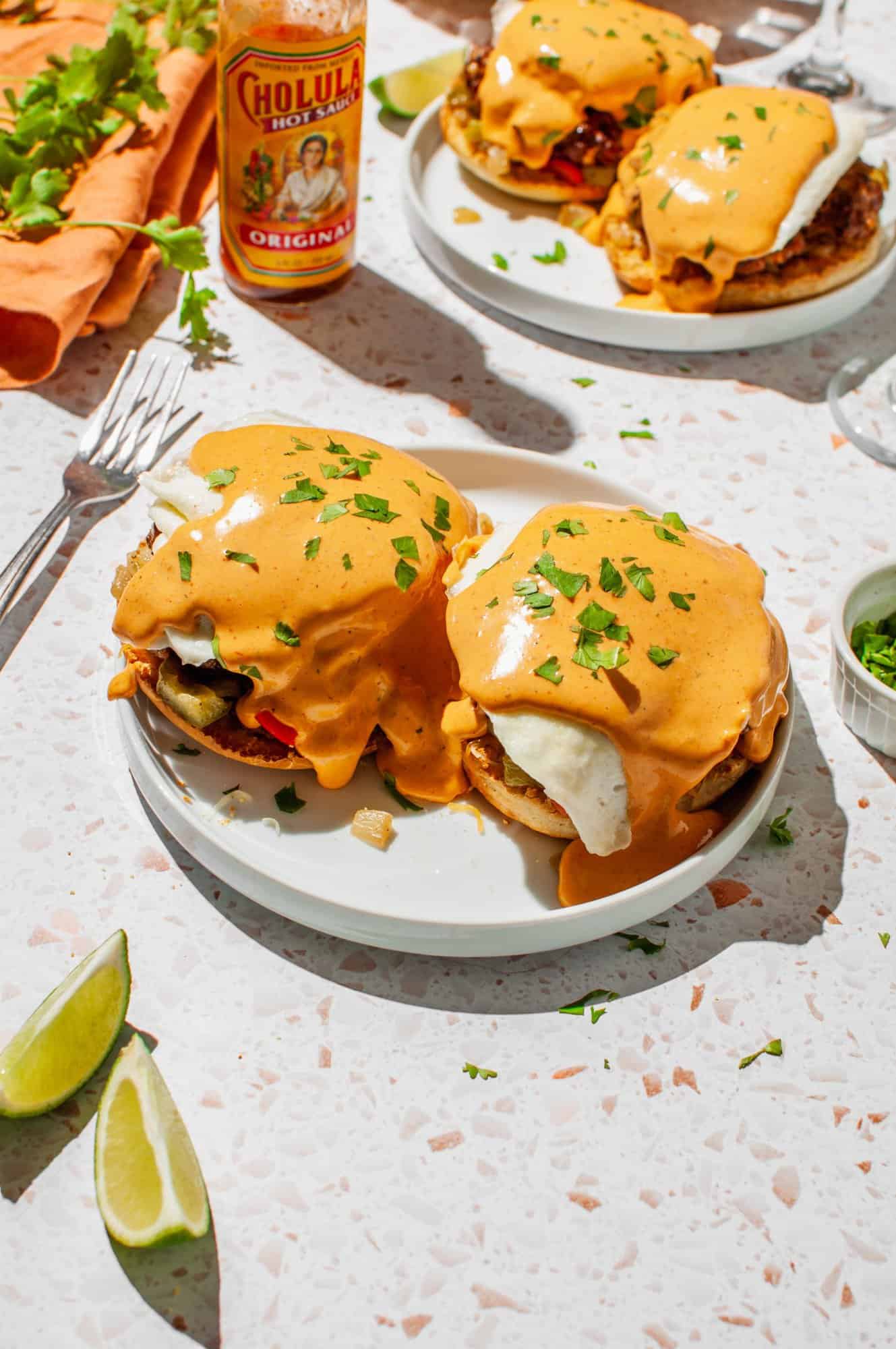 Eggs benedict with chipotle hollandaise and fresh cilantro on a plate