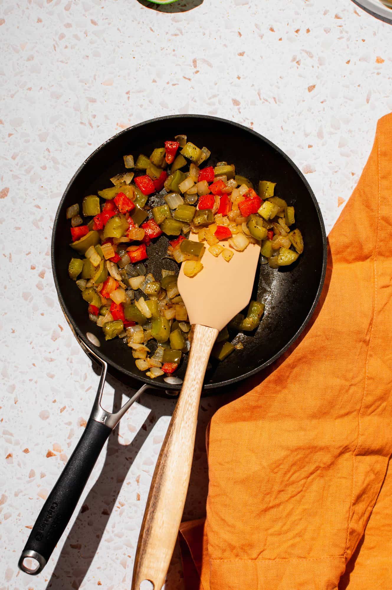 Diced red and green pepper and onion in a pan