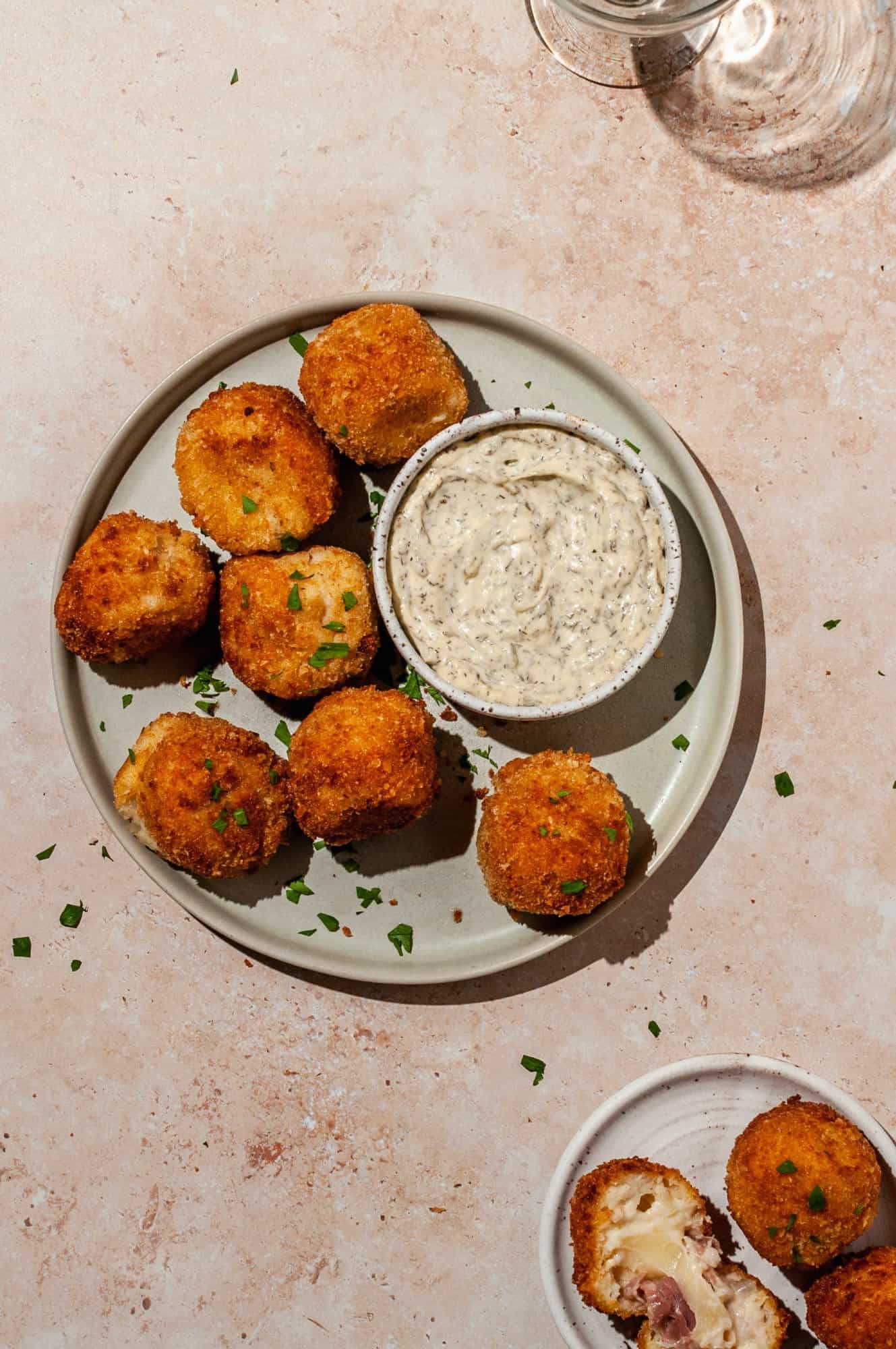 air fried ham and cheese croquettes on a platter with aioli on the side for dipping