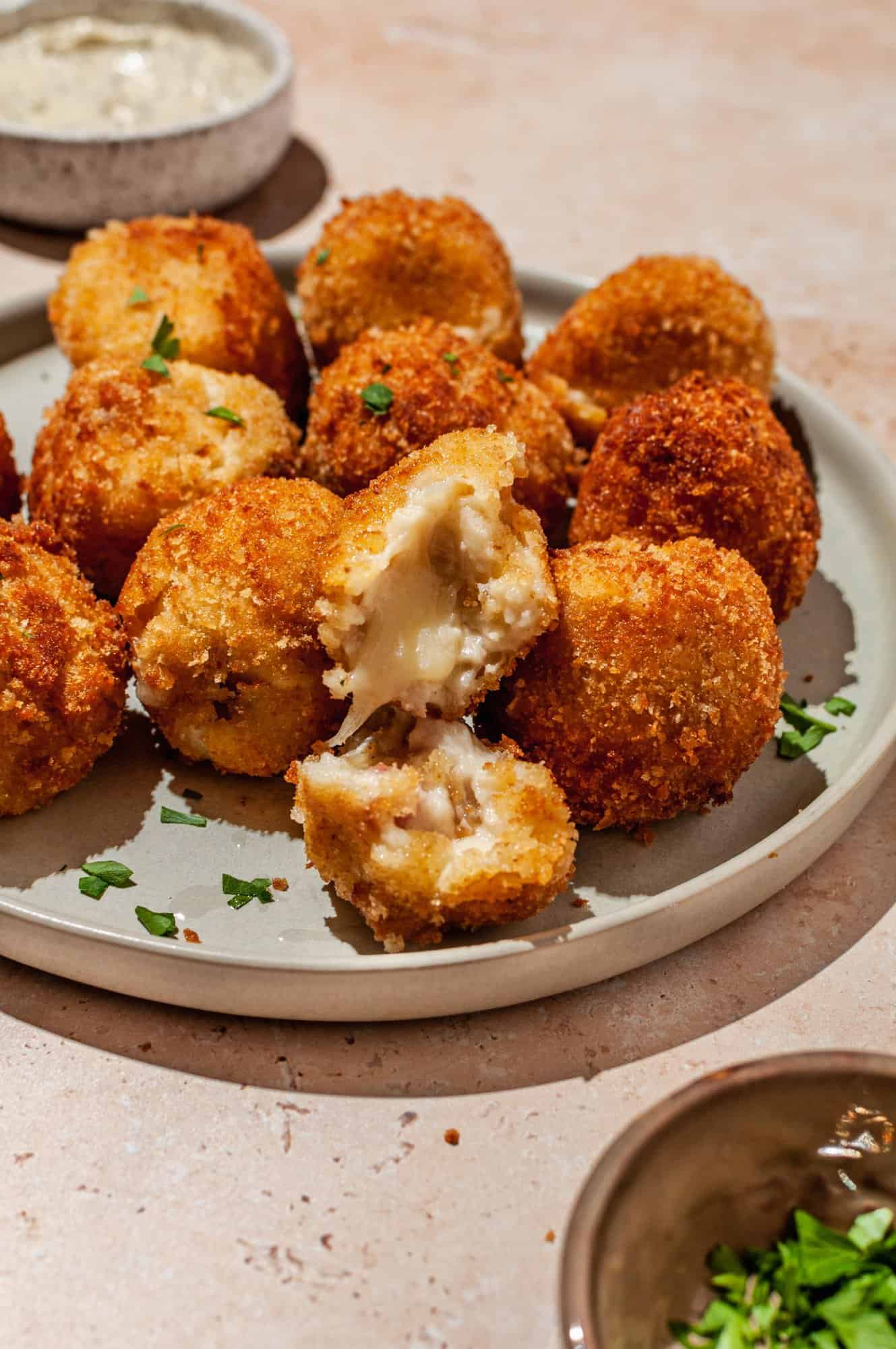 platter of ham and cheese croquettes garnished with parsley