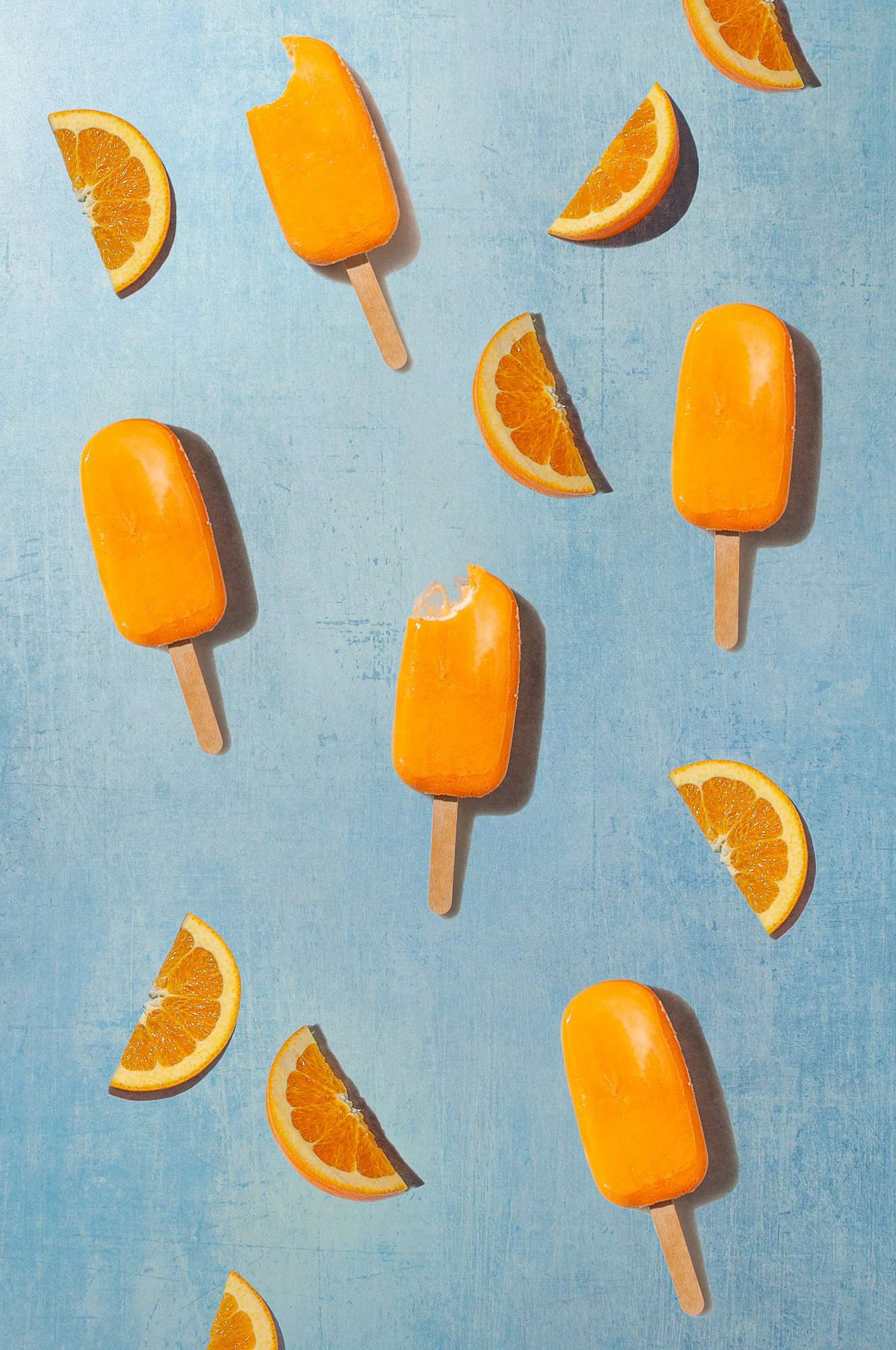 pattern with five orange creamsicle popsicles and orange slices