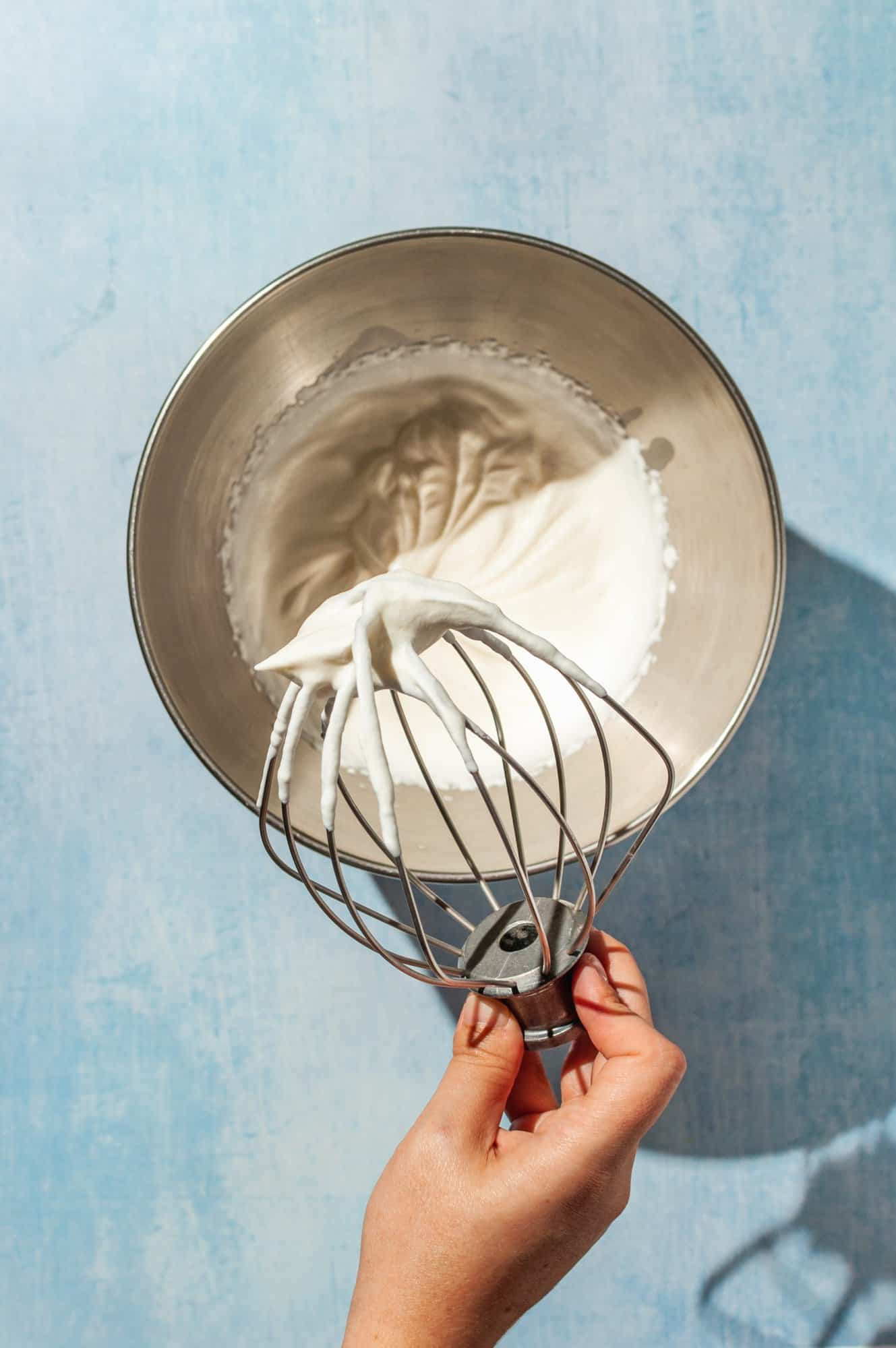whisk over bowl of whipped cream whipped to stiff peaks