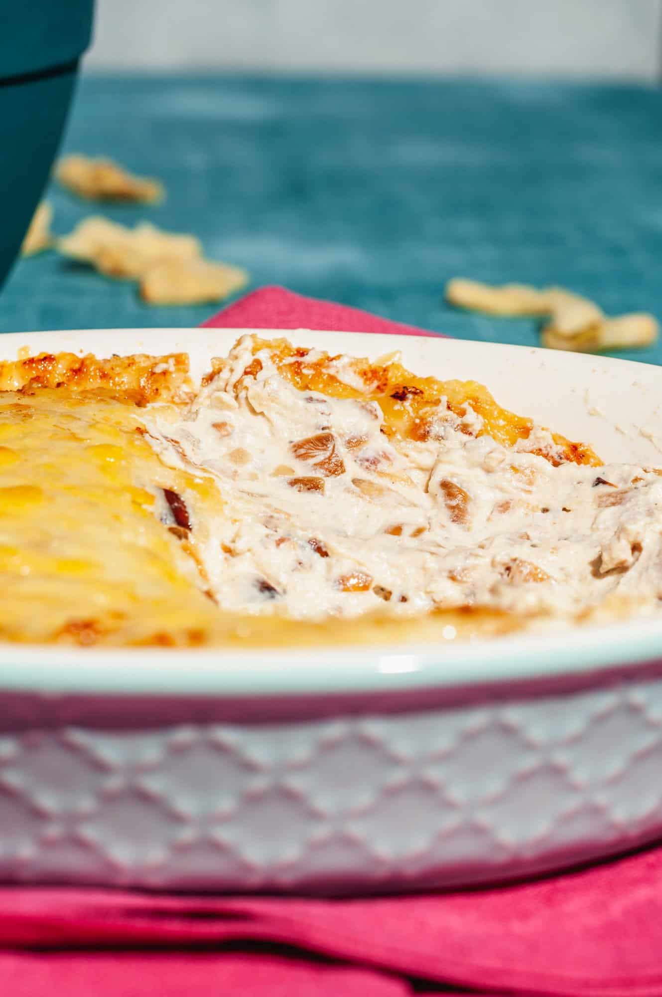 close up of caramelized onion dip with gruyere in baking dish