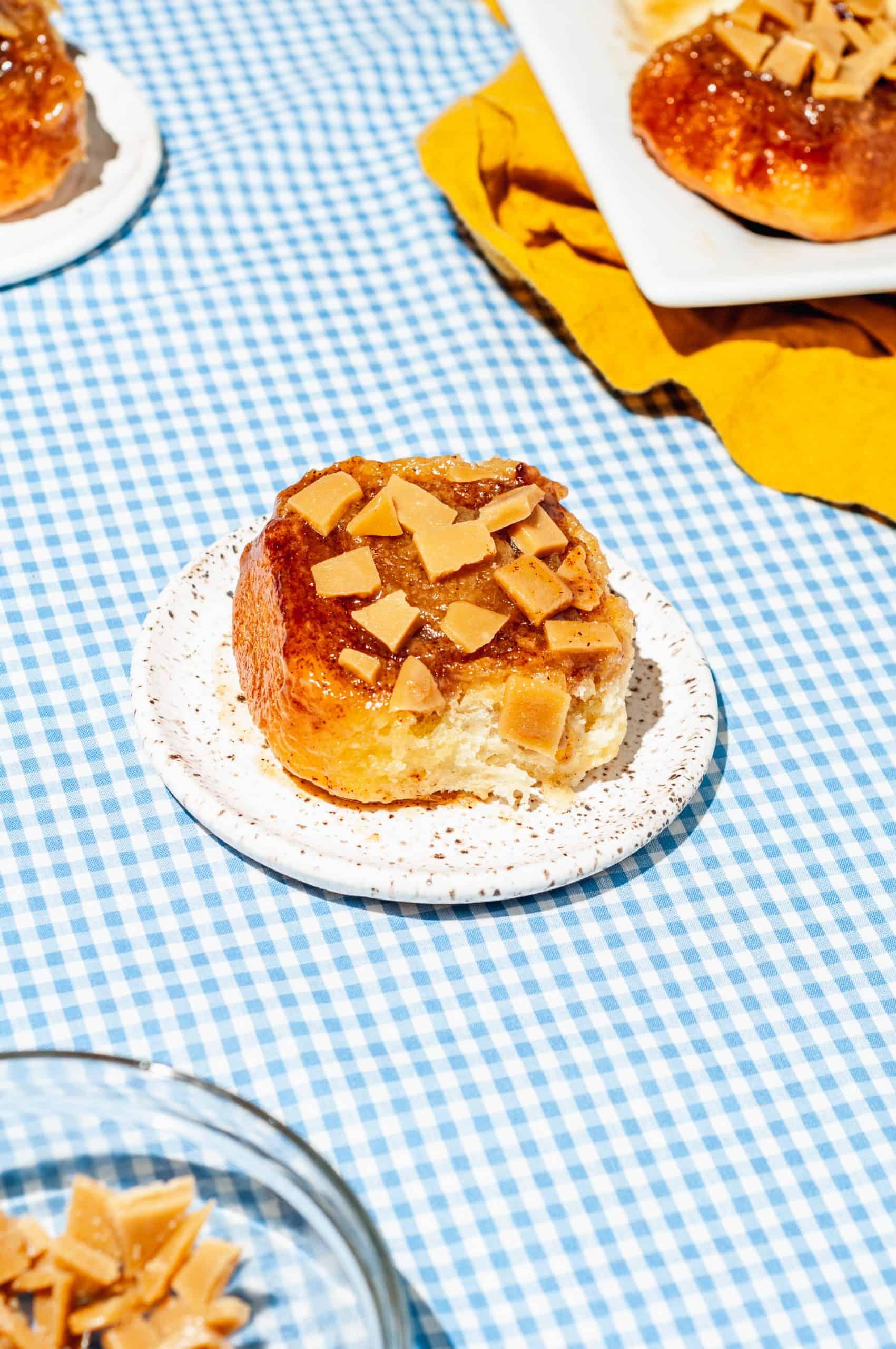 one sticky bun on a plate, platter in background