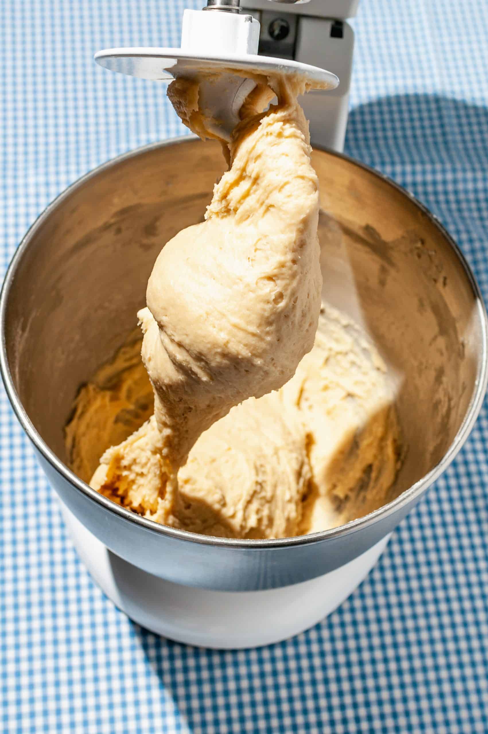 yeasted dough in stand mixer hanging off dough hook