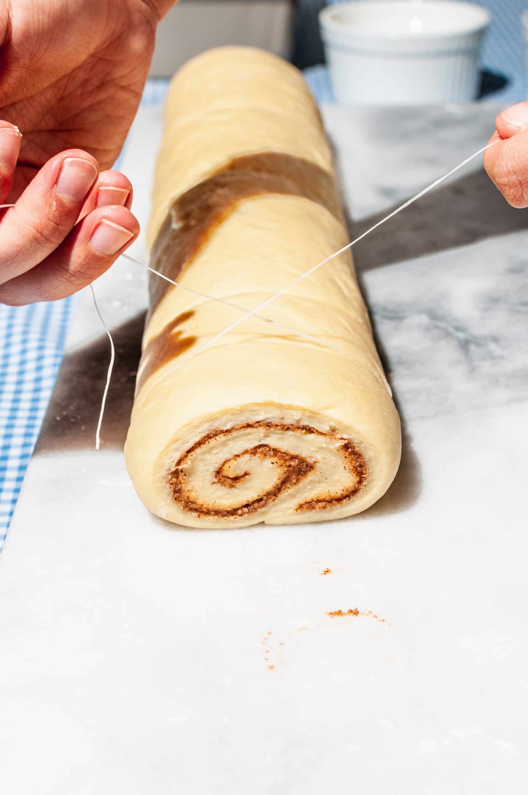cutting sticky bun log with unflavored dental floss