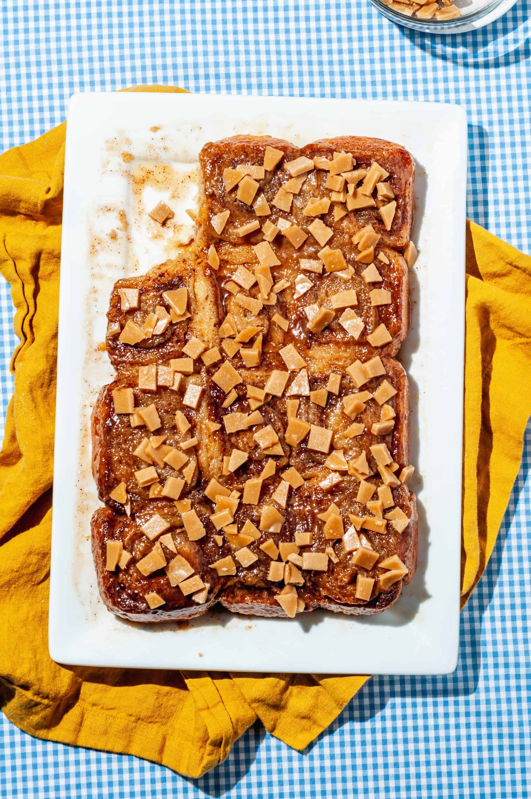 sticky buns topped with toffee bits on platter