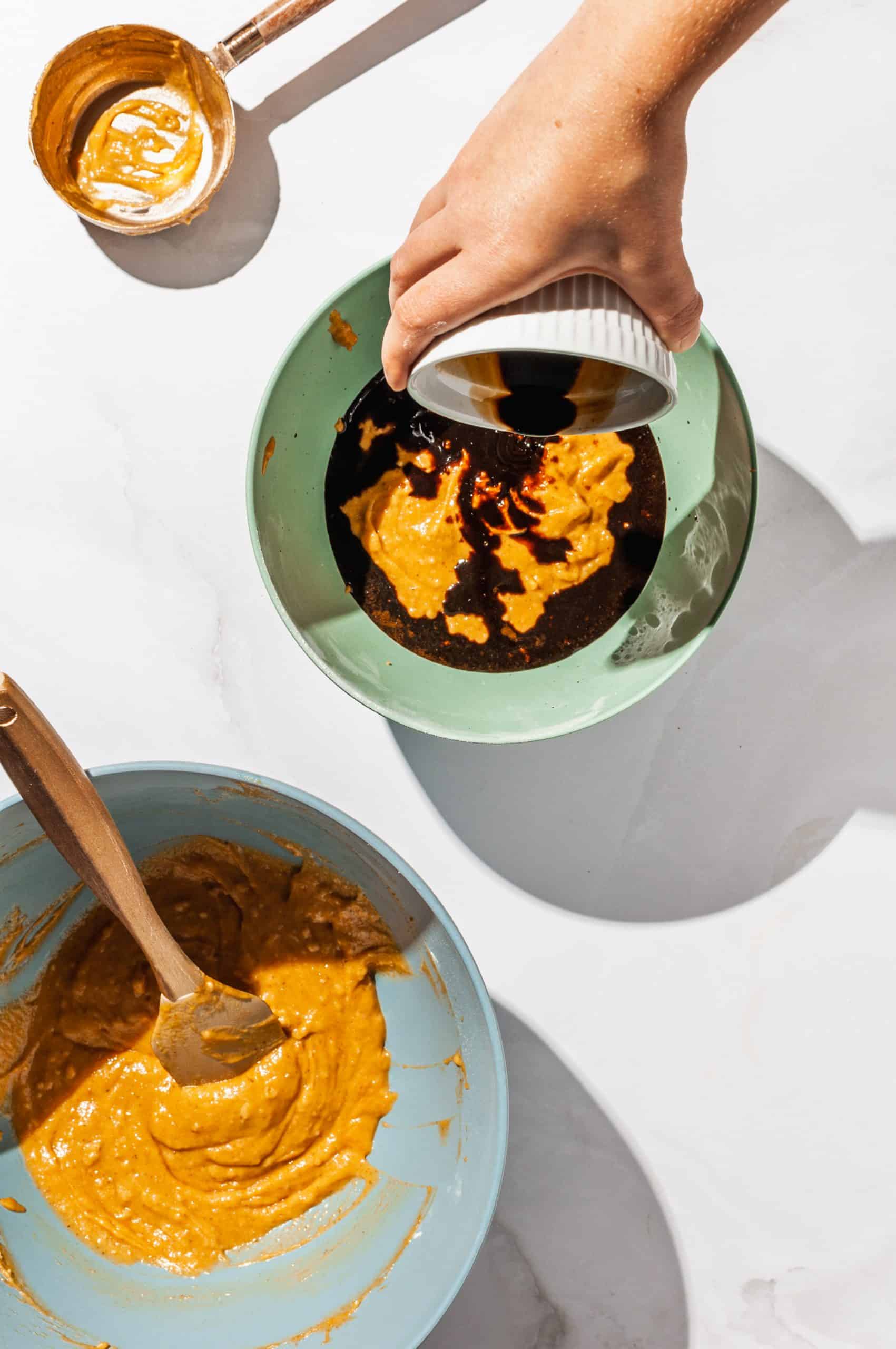 pouring coffee into half of the pumpkin batter