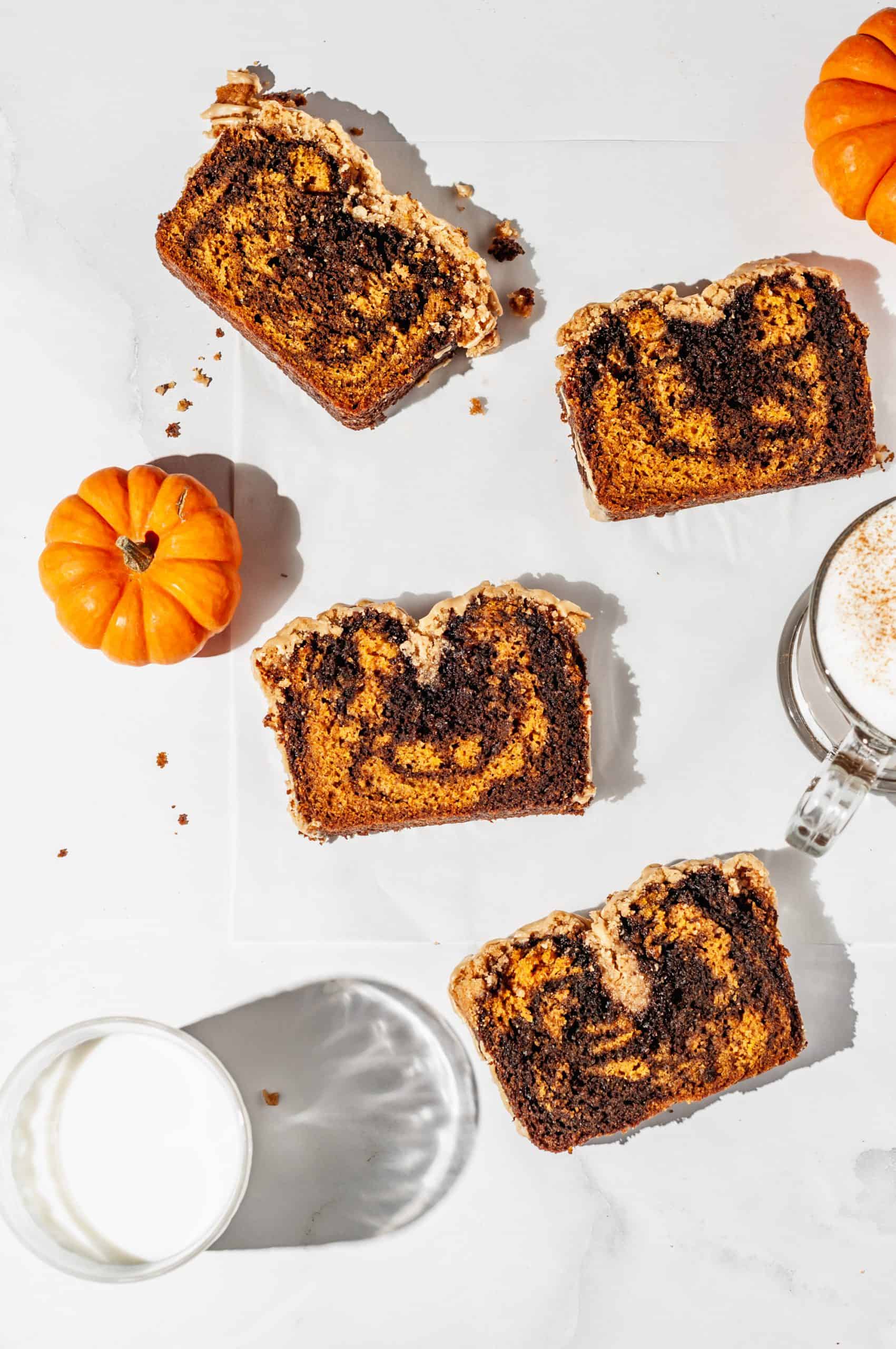 4 slices of pumpkin spice latte bread on waxed paper with milk and latte on the side