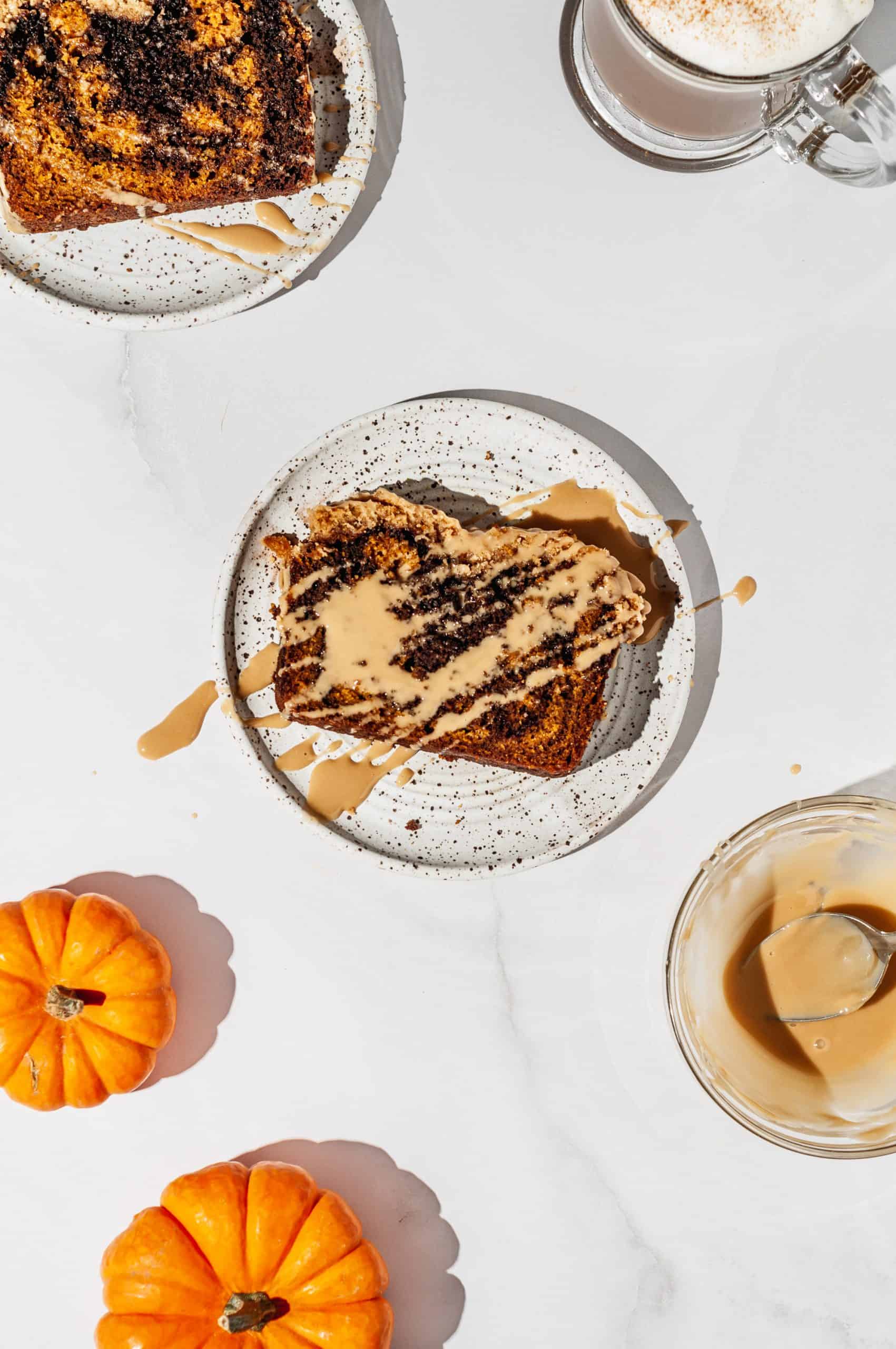 slice of pumpkin spice latte bread drizzled with extra maple coffee icing