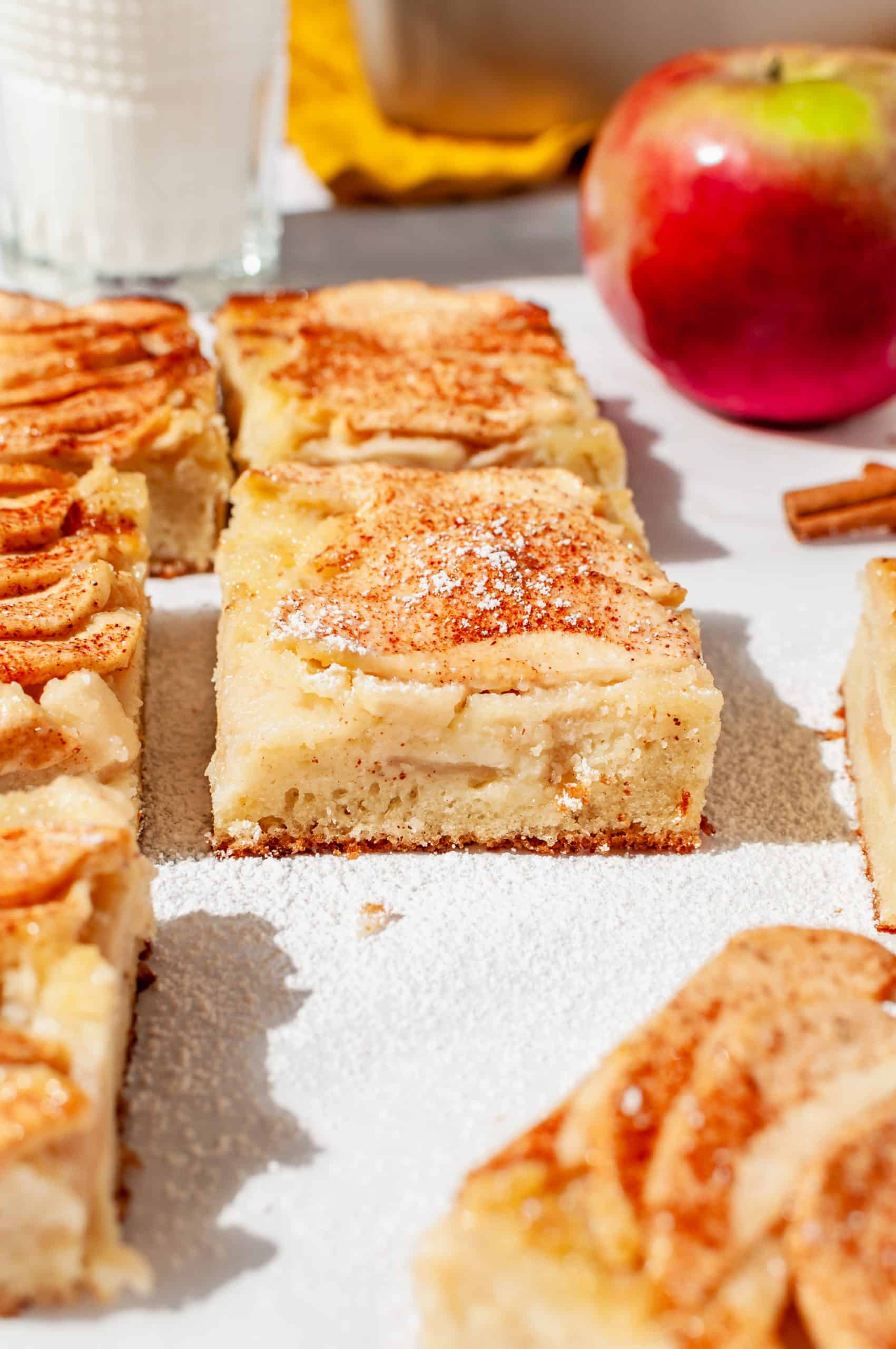 piece of apple snack cake showing inside moist texture and layers of sliced apples