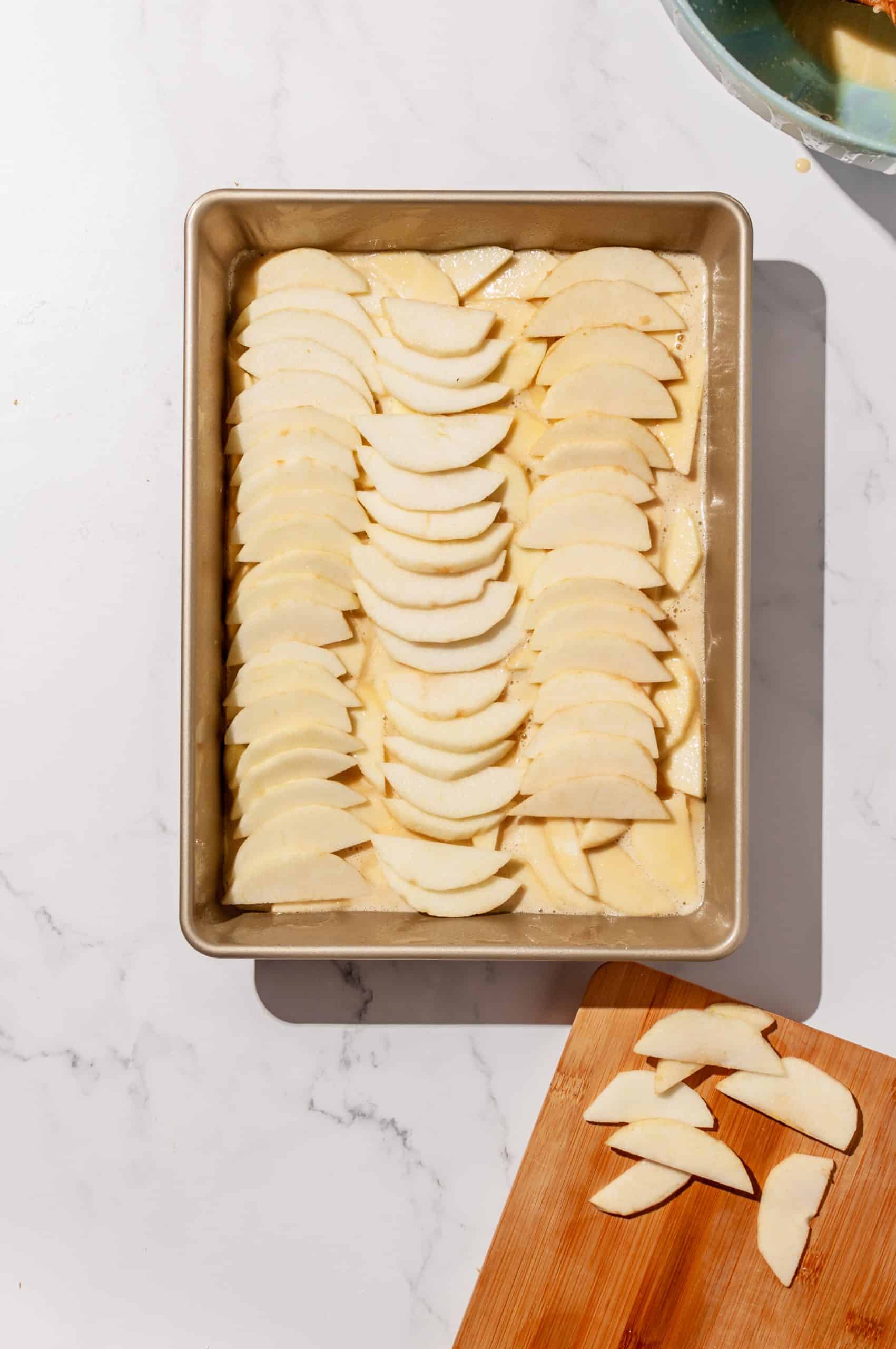 apple slices shingled in 3 columns vertically for top layer of apple snack cake