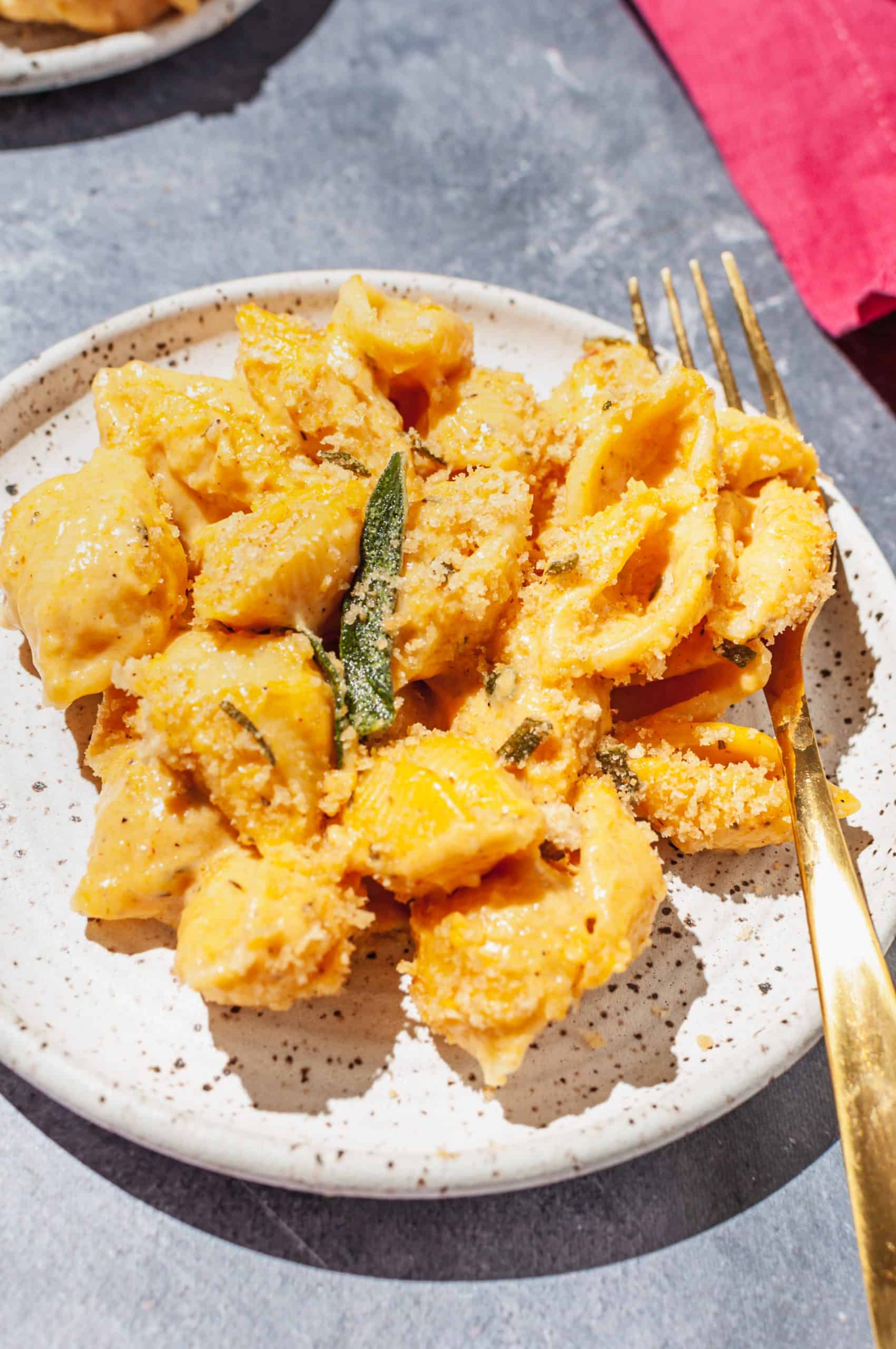 close up pumpkin mac and cheese with sage breadcrumbs on a plate