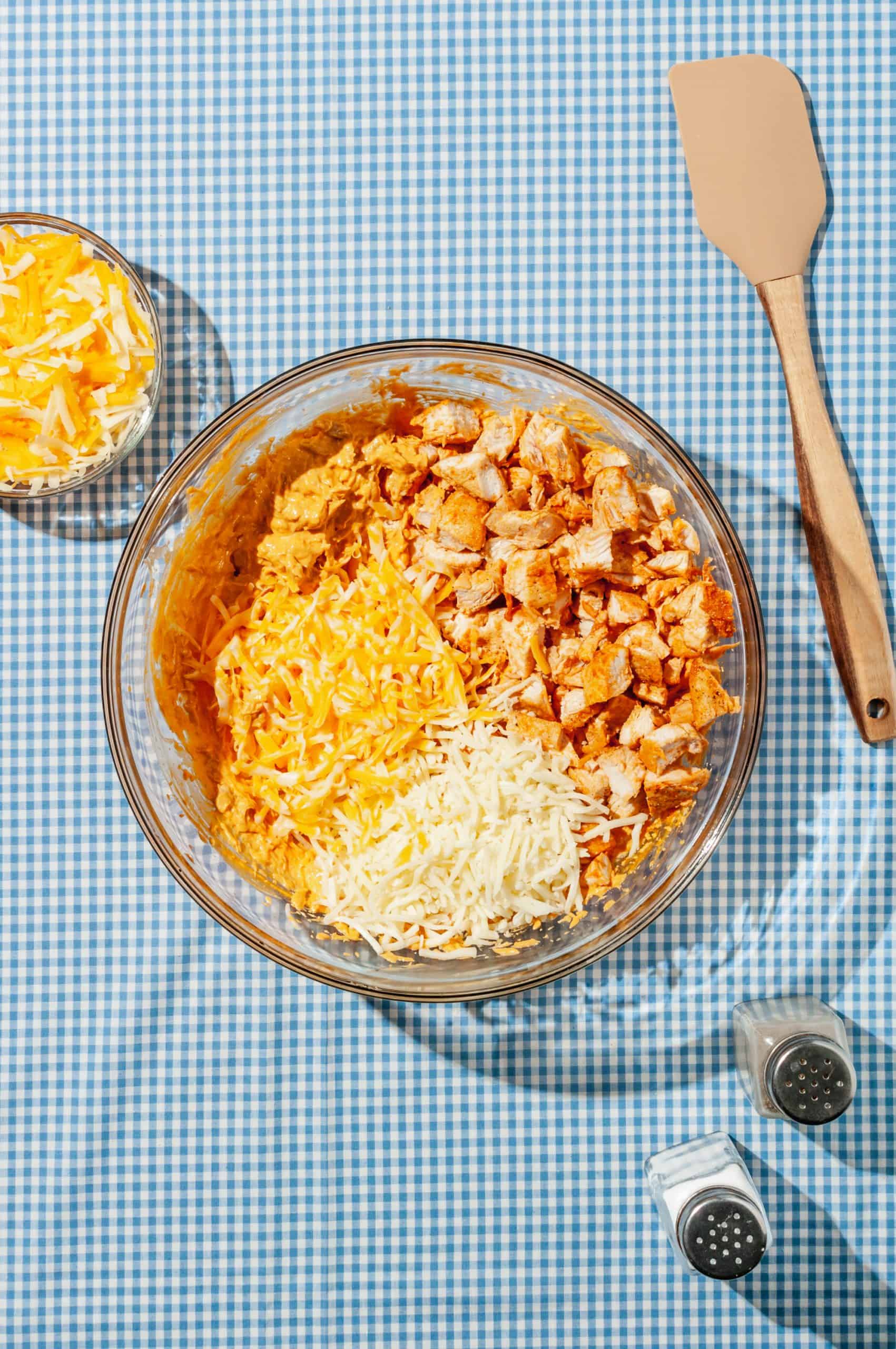 diced chicken, shredded cheese, and hot sauce mixture in a large mixing bowl