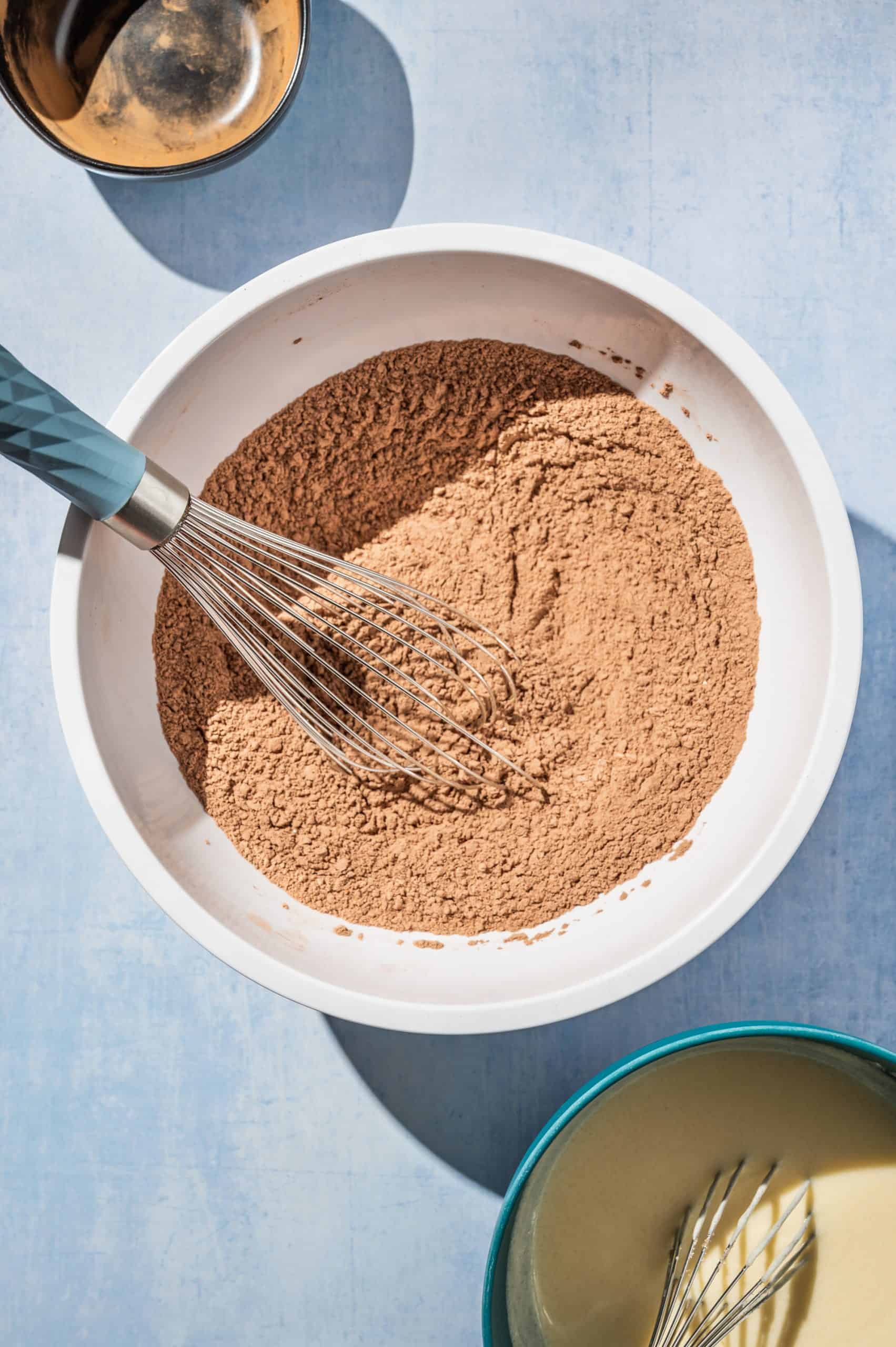 mixing bowl with cocoa powder, flour, and other dry ingredients whisked together