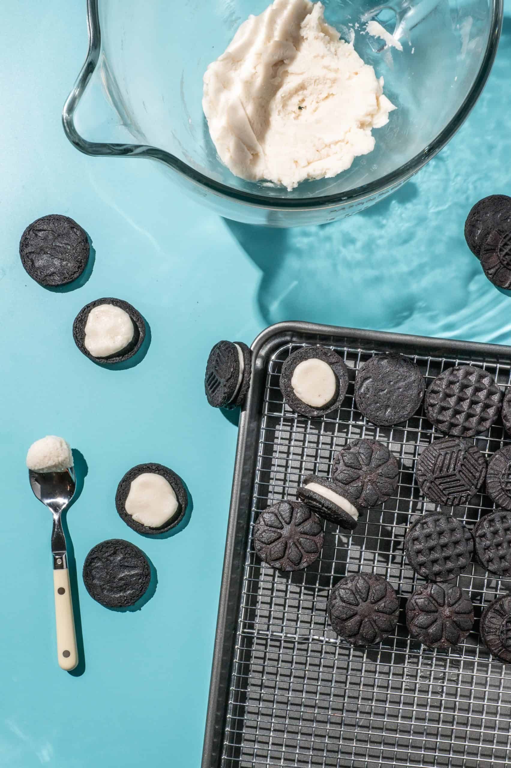 process shot showing oreo filling on chocolate wafer cookies before sandwiching together for homemade oreos