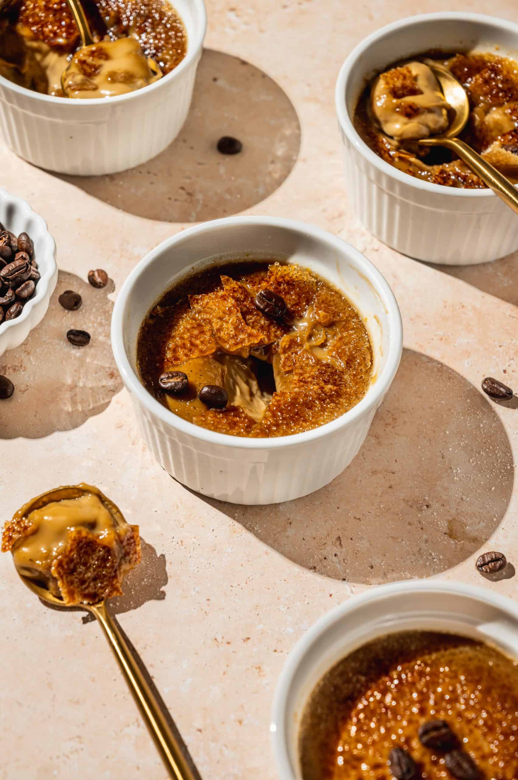 ramekin with coffee creme brulee broken into to show creamy inside