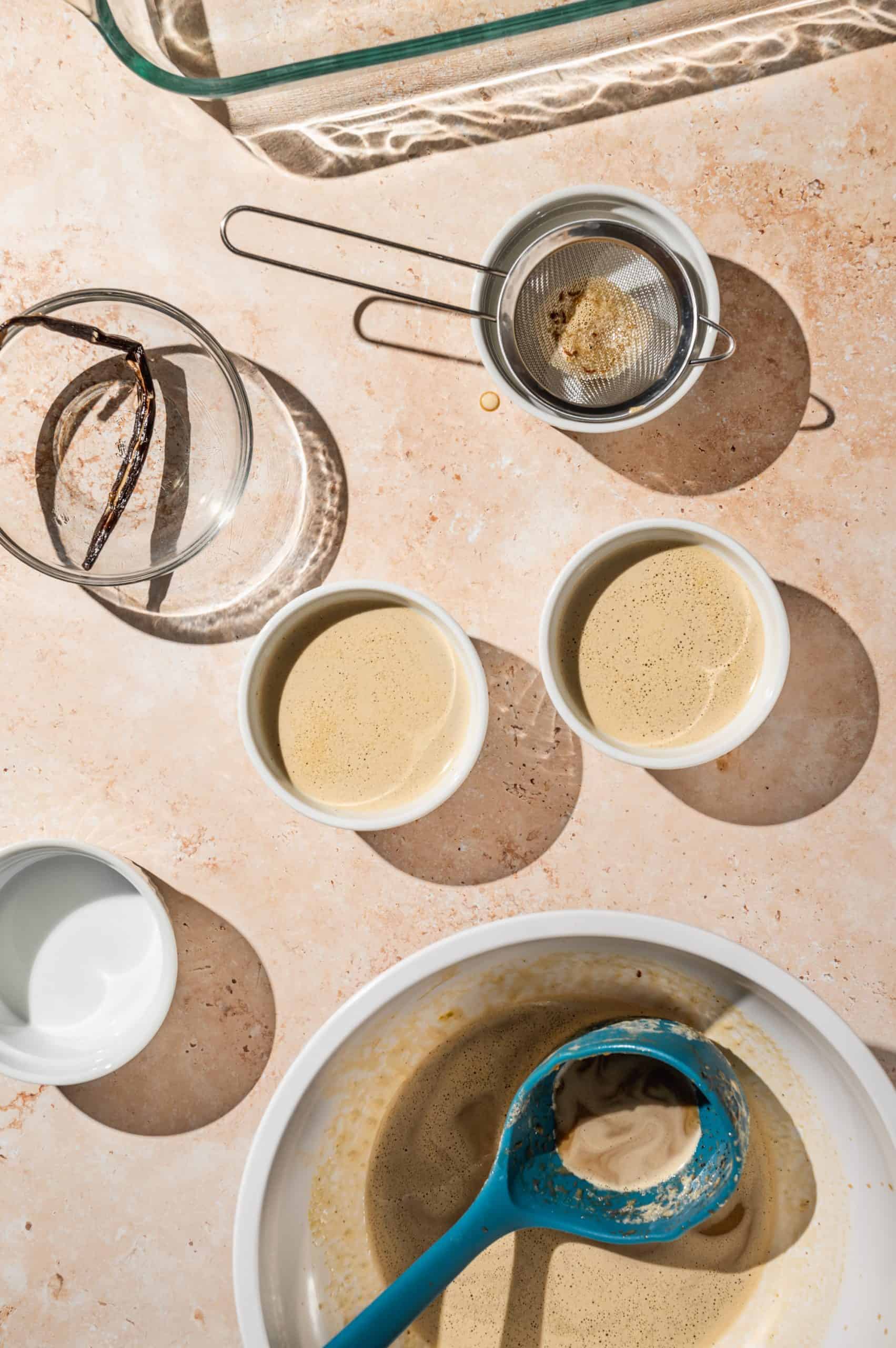 filling ramekins with coffee custard mixture passed through a small strainer