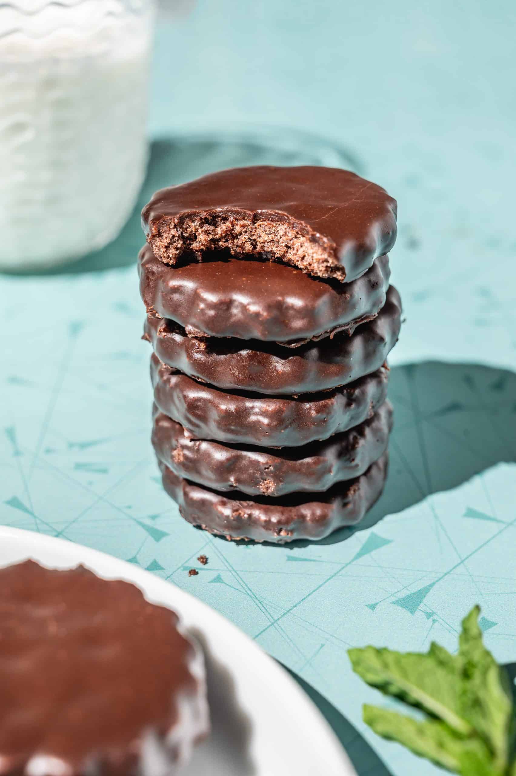 stack of copycat thin mints, the top cookie has a bite taken out to show inside texture