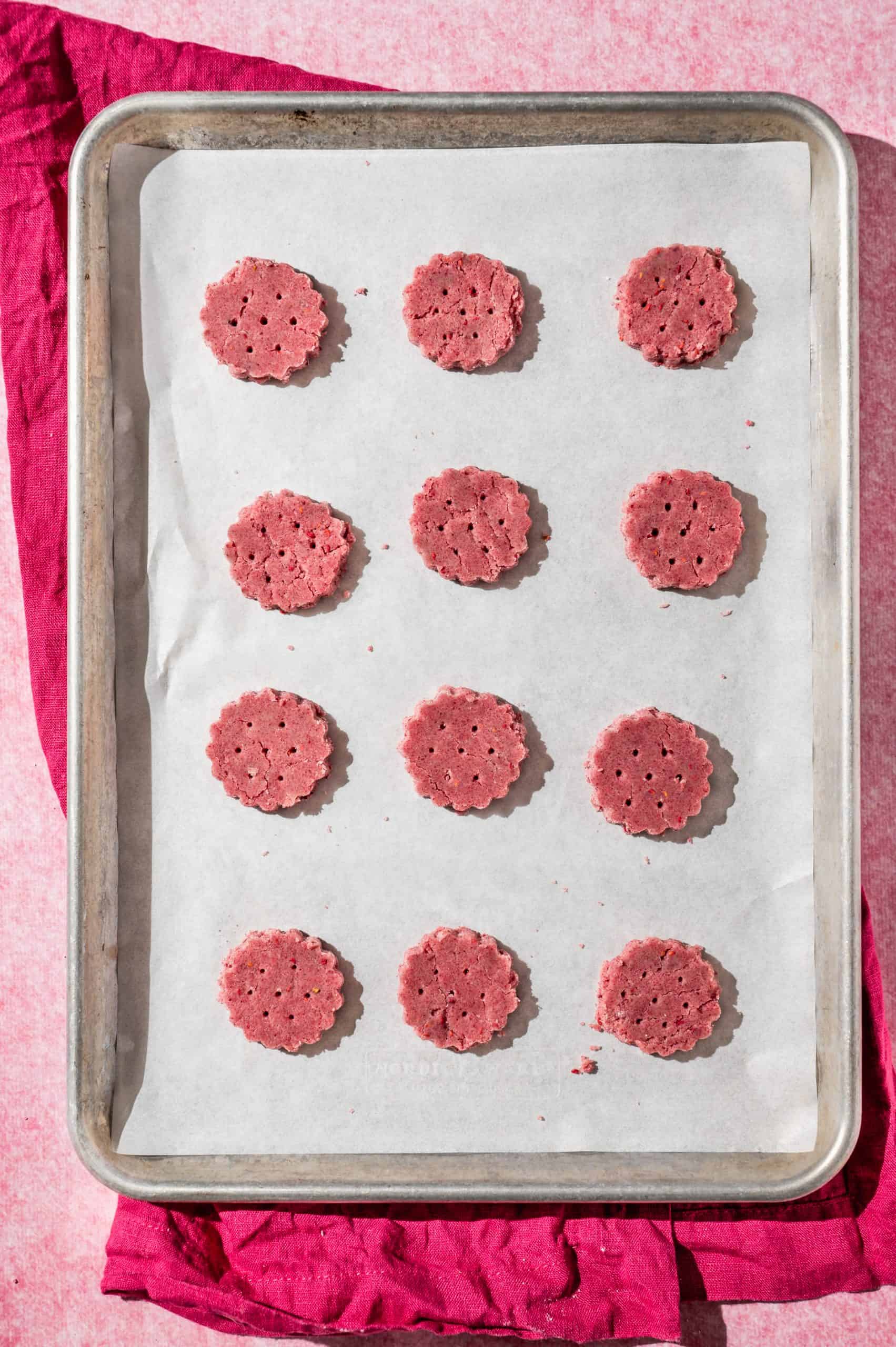 raspberry wafer cookies on a baking sheet lined with parchment paper before baking
