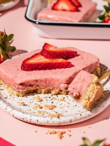 strawberry pie bar on a plate with a bite taken out