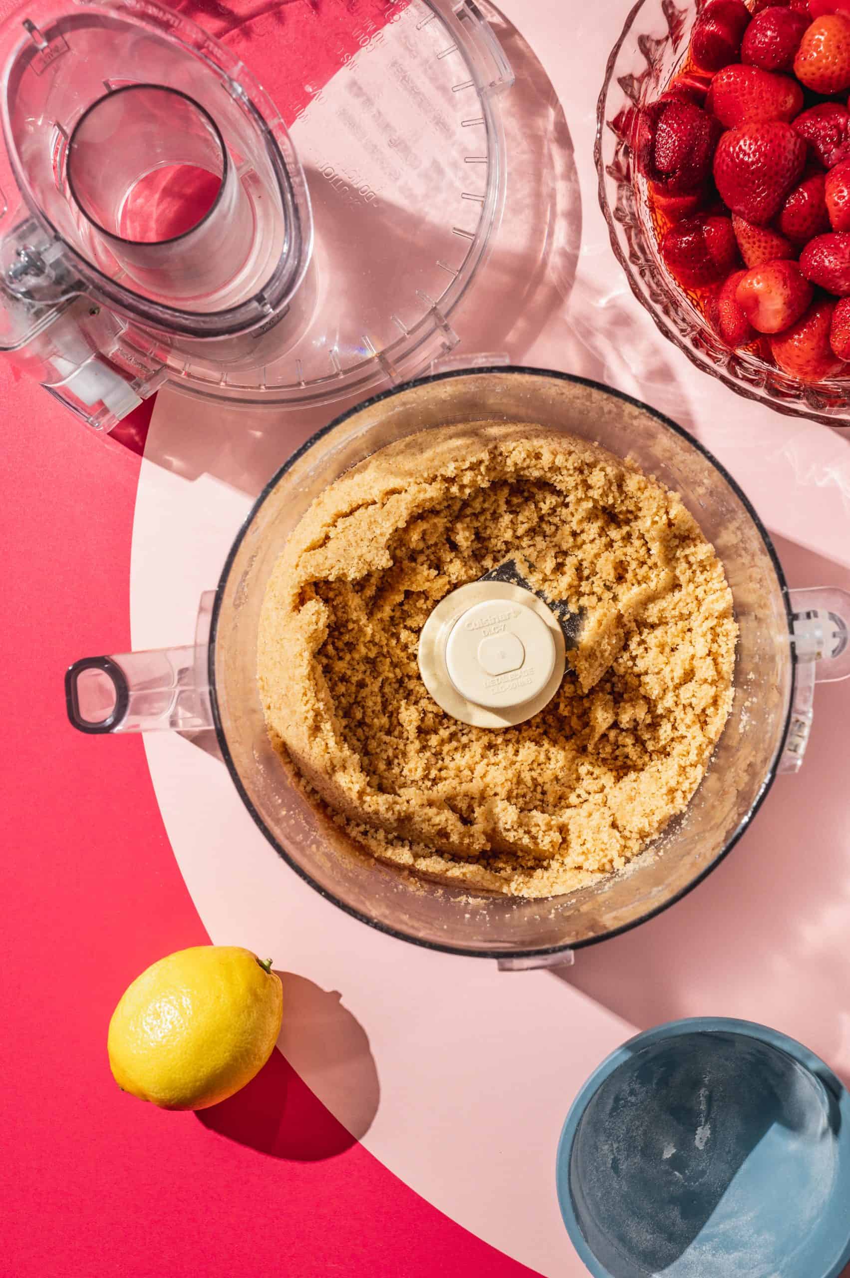 graham cracker crumb mixture in the bowl of a food processor