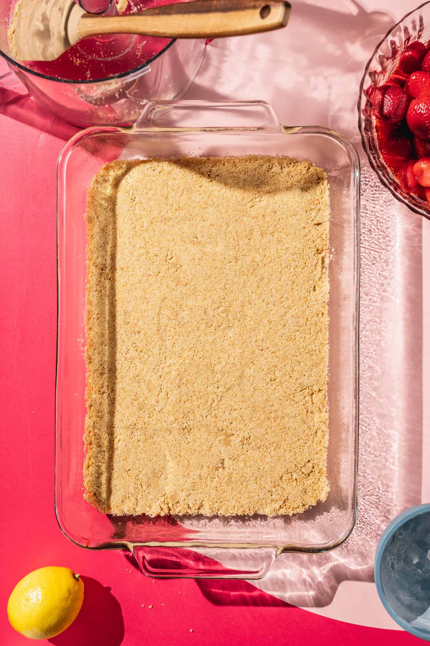 graham cracker crust pressed into a rectangular glass baking dish