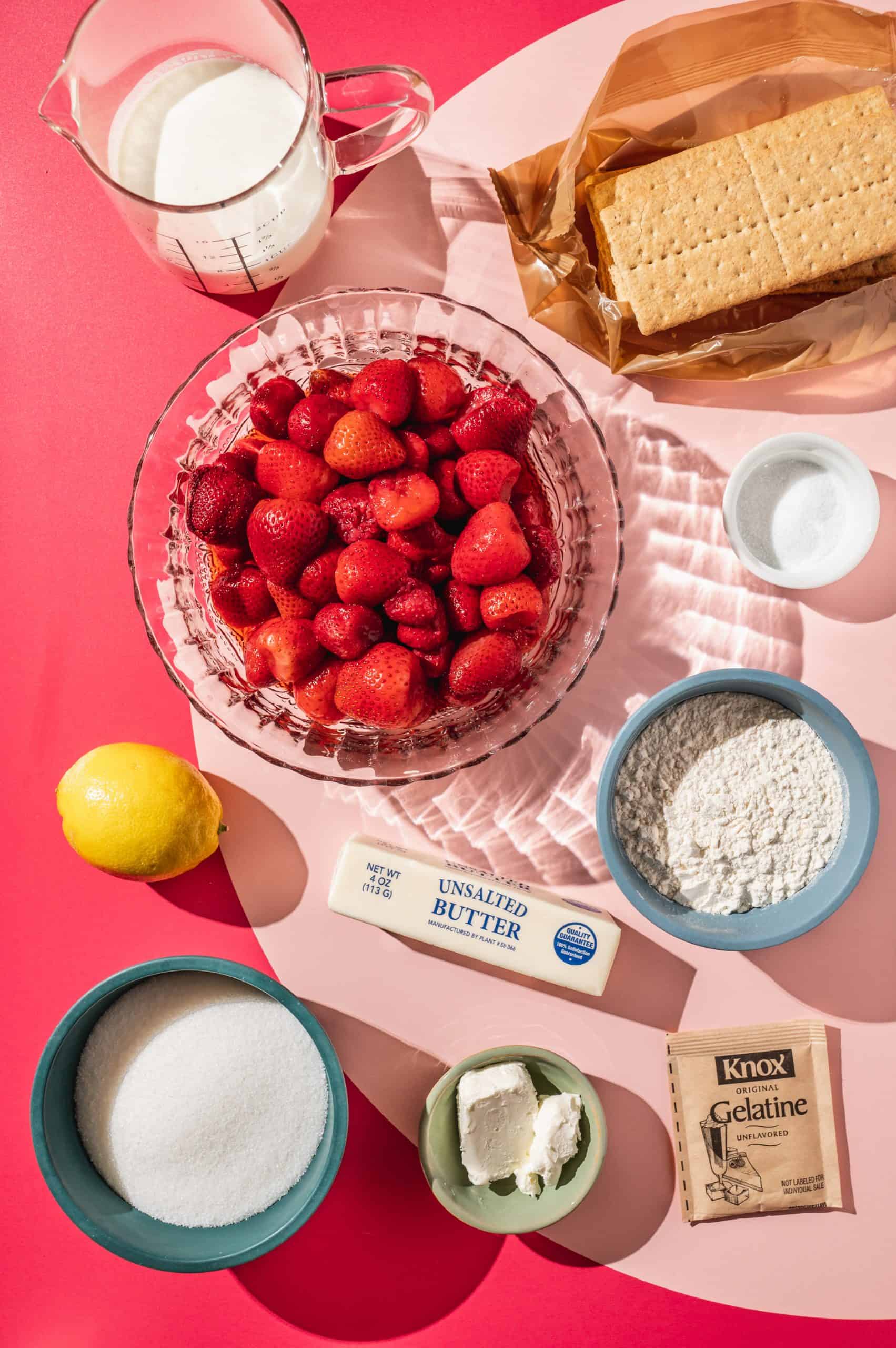 ingredients to make strawberry pie bars: graham crackers, berries, flour, sugar, gelatin, cream, butter, lemon, salt, cream cheese