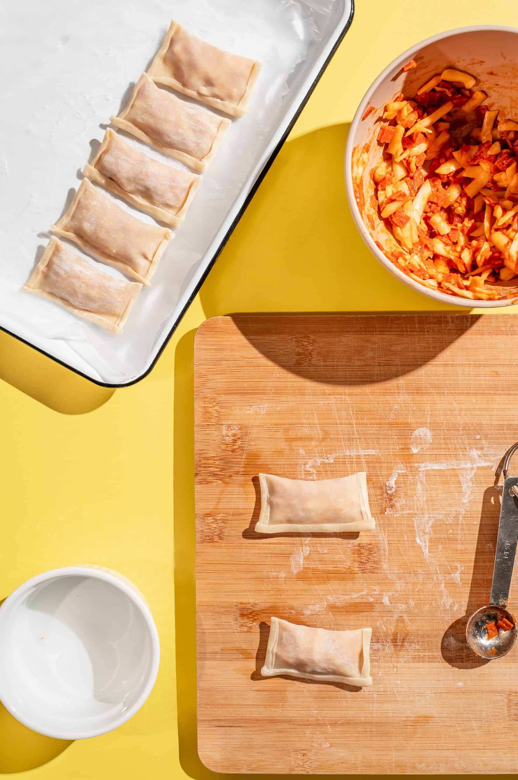 fold the long edge of the homemade pizza roll and seal with water to fully enclose the filling