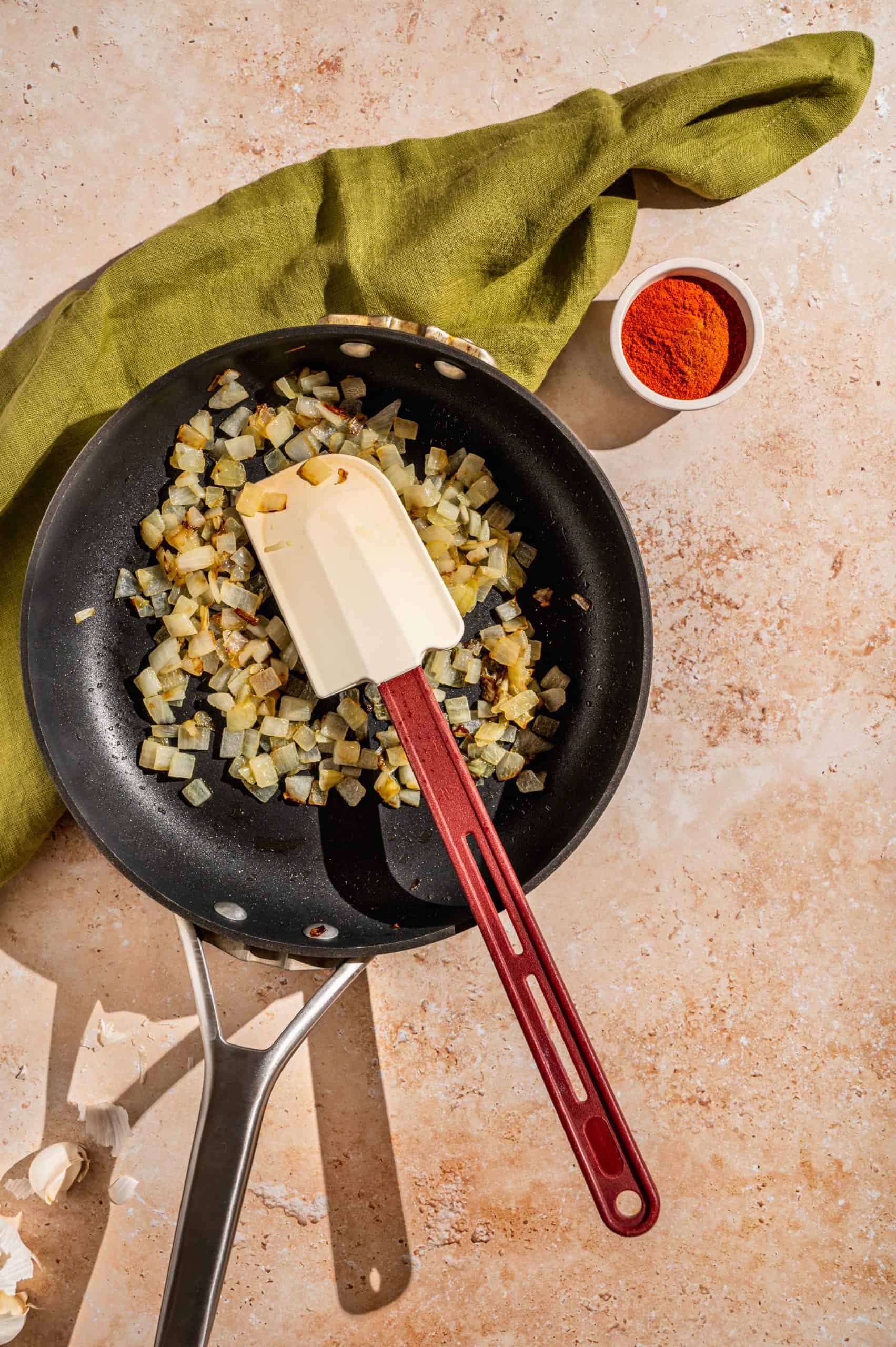 saucepan with diced onions in oil, translucent and starting to brown on the edges