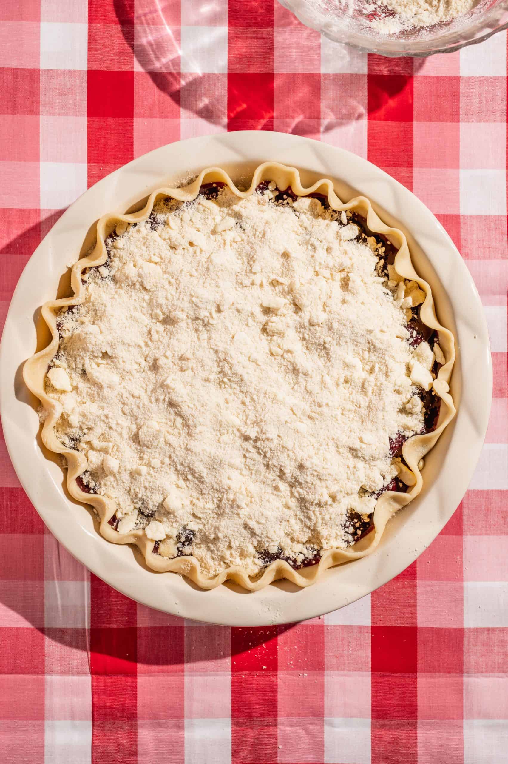 uncooked cherry crumble pie before baking