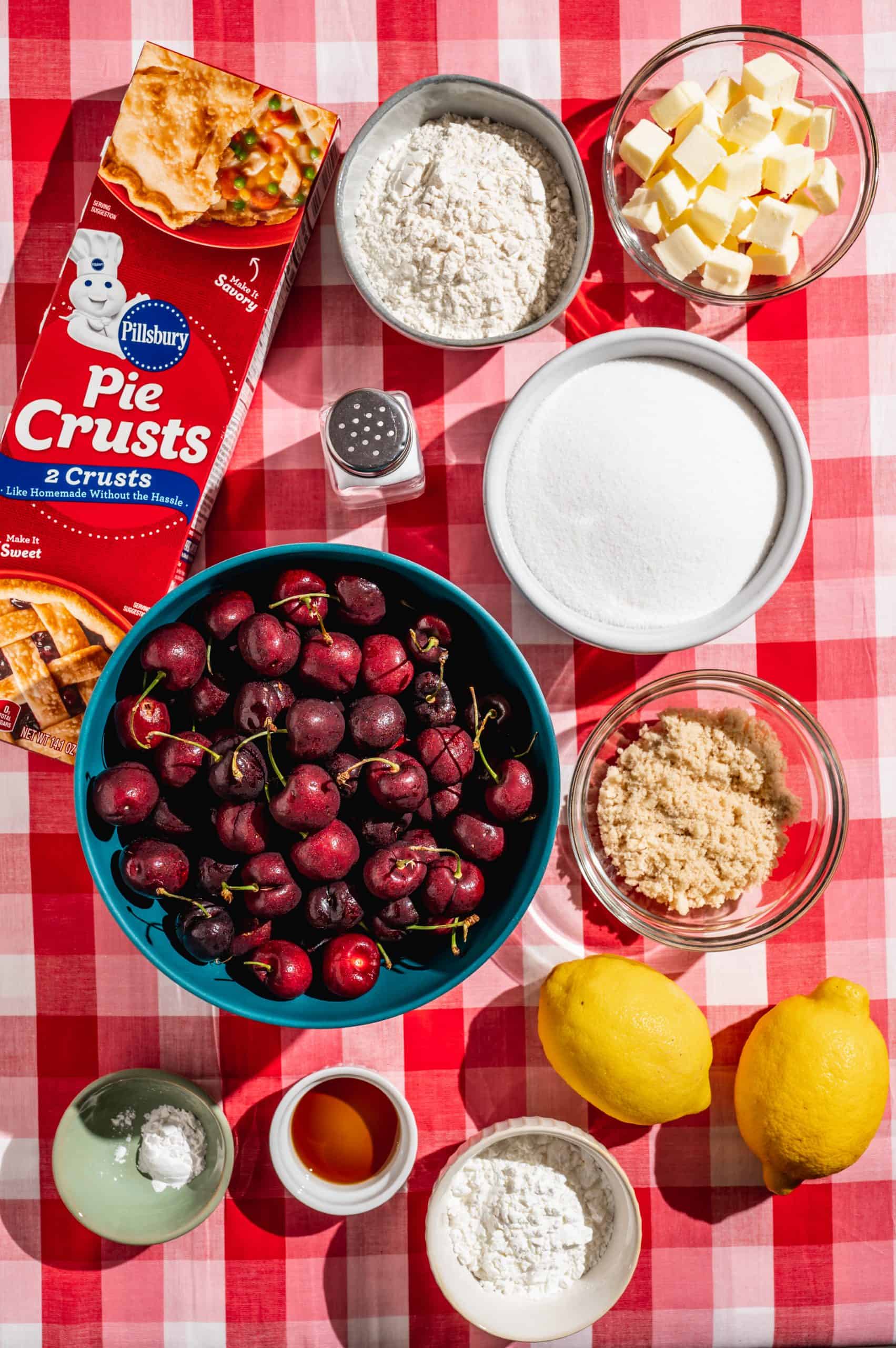 ingredients to make cherry crumble pie: cherries, pie crust, sugars, butter, flour, lemon juice, vanilla, salt