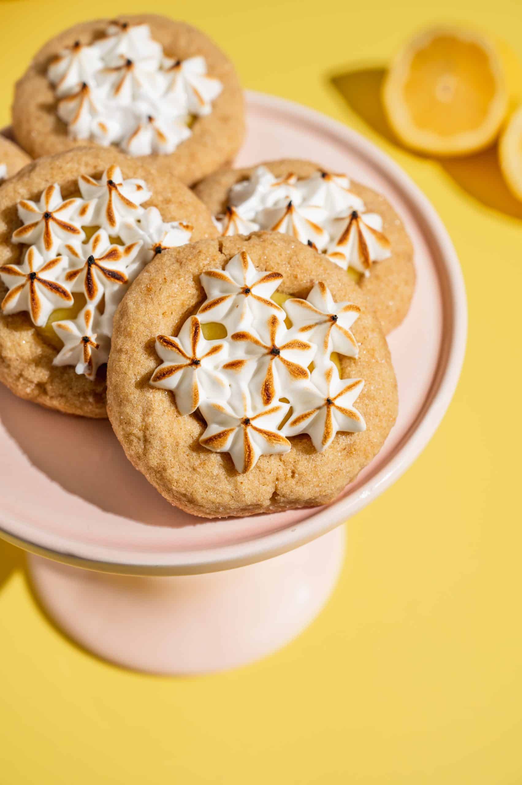 5 lemon meringue cookies on a light pink platter