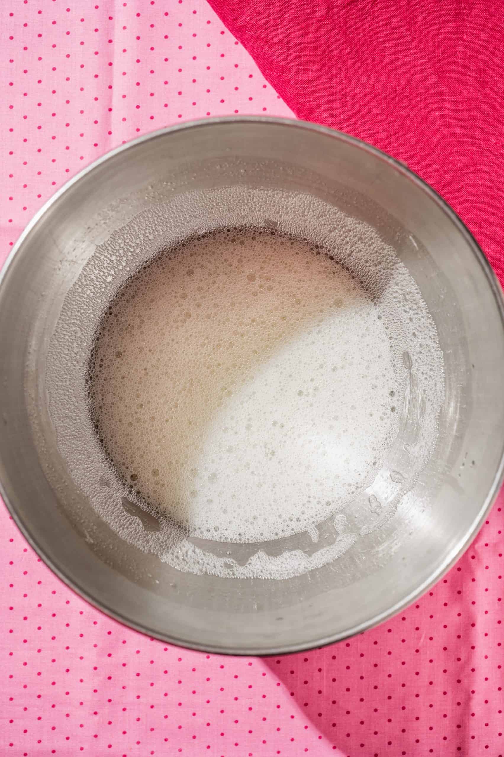 whipped frothy egg whites in the bowl of a stand mixer